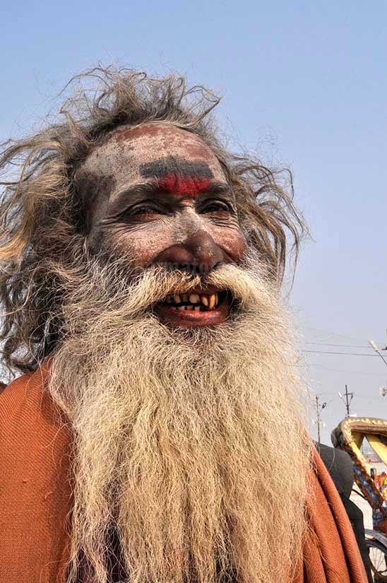 Culture- Aghori Sadhu, Uttar Pradesh (India). Smile of an old Aghori Sadhu with long hairs, ash on face at Mahakumbh Prayag, Allahabad, Uttar Pradesh (India). by Anil