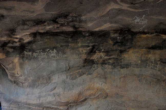 Archaeology- Bhimbetka Rock Shelters (India) Prehistoric Rock Painting showing hunters riding horses in white color at Bhimbetka archaeological site, Raisen, Madhya Pradesh, India by Anil