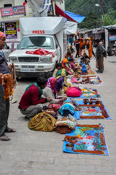 Travel- Gangotri (Uttarakhand) Gangotri, Uttarakhand, India- June 14, 2013: Local people selling beads, jewelry, gemstones, bracelets, earrings, bangles, on the road side at Gangotri, Uttarkashi, Uttarakhand, India. by Anil