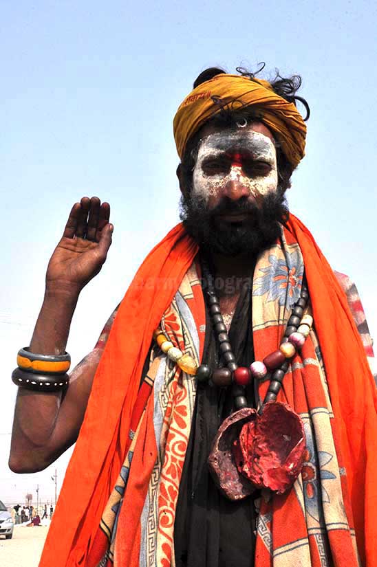 Culture- Aghori Sadhu, Uttar Pradesh (India). Aghori Sadhu with long hairs, ash on the face, wearing human bones and rudraksha bead at Mahakumbh Allahabad. by Anil