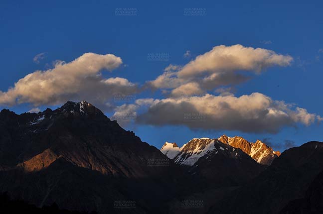 Clouds- Sky with Clouds (Leh) Clouds over peaks, Leh, Jammu and Kashmir, India- September 25, 2011: Dark blue sky with white clouds floating over the snow covered peaks at Leh, Jammu and Kashmir, India. by Anil