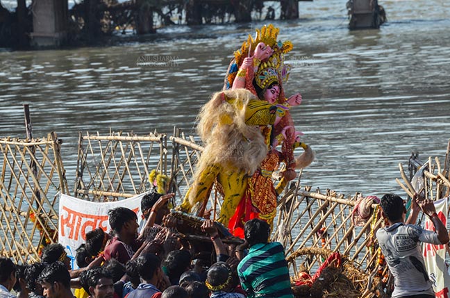 Festivals- Durga Puja Festival Durga Puja Festival, New Delhi, India-September 30, 2017: Hindu devotees immersing idol of Goddess Durga in river Yamuna at Kalindi Kunj, New Delhi, India. by Anil