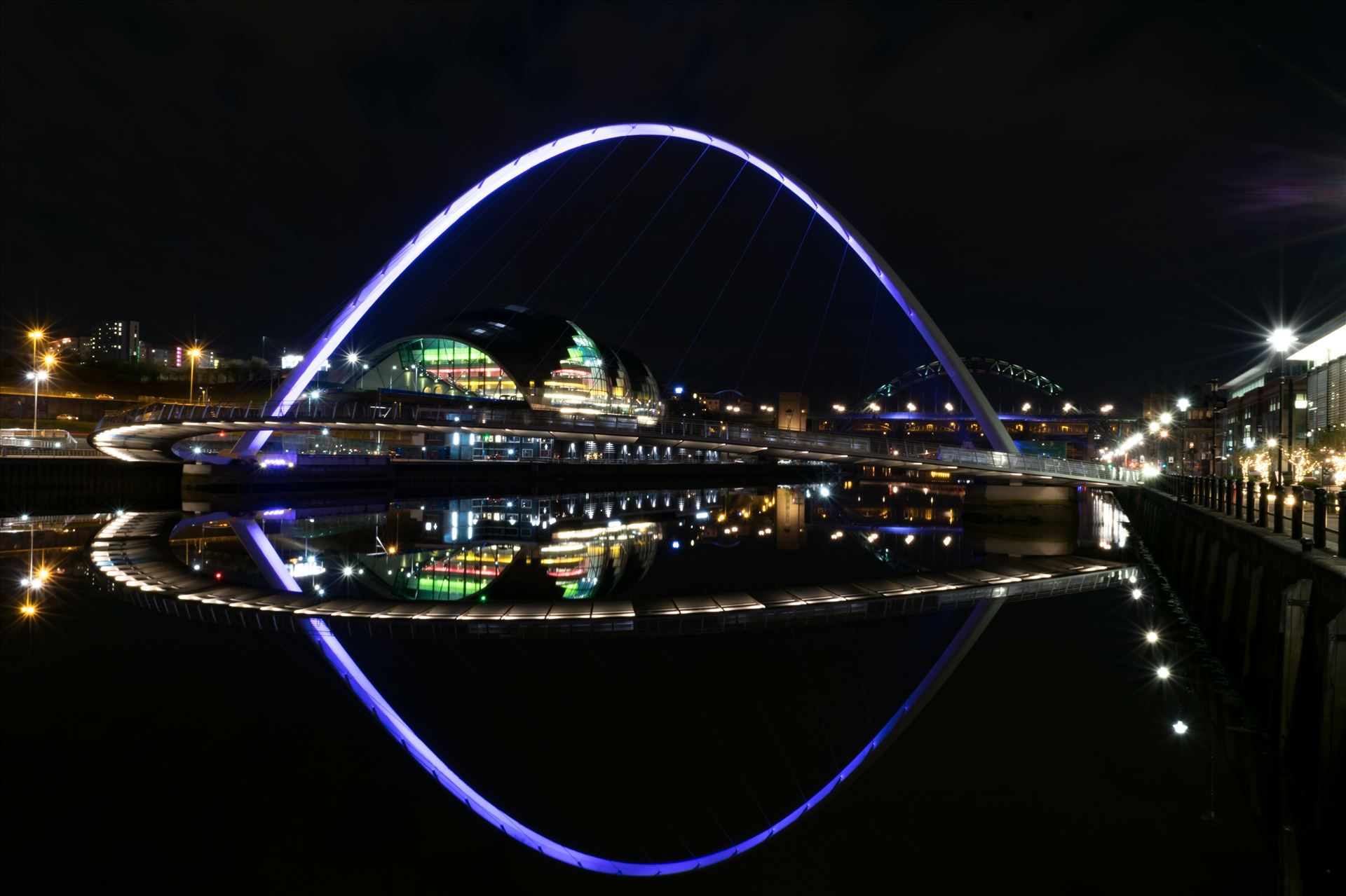 Millennium Bridge and Baltic Reflection Millennium Bridge at night by AJ Stoves Photography
