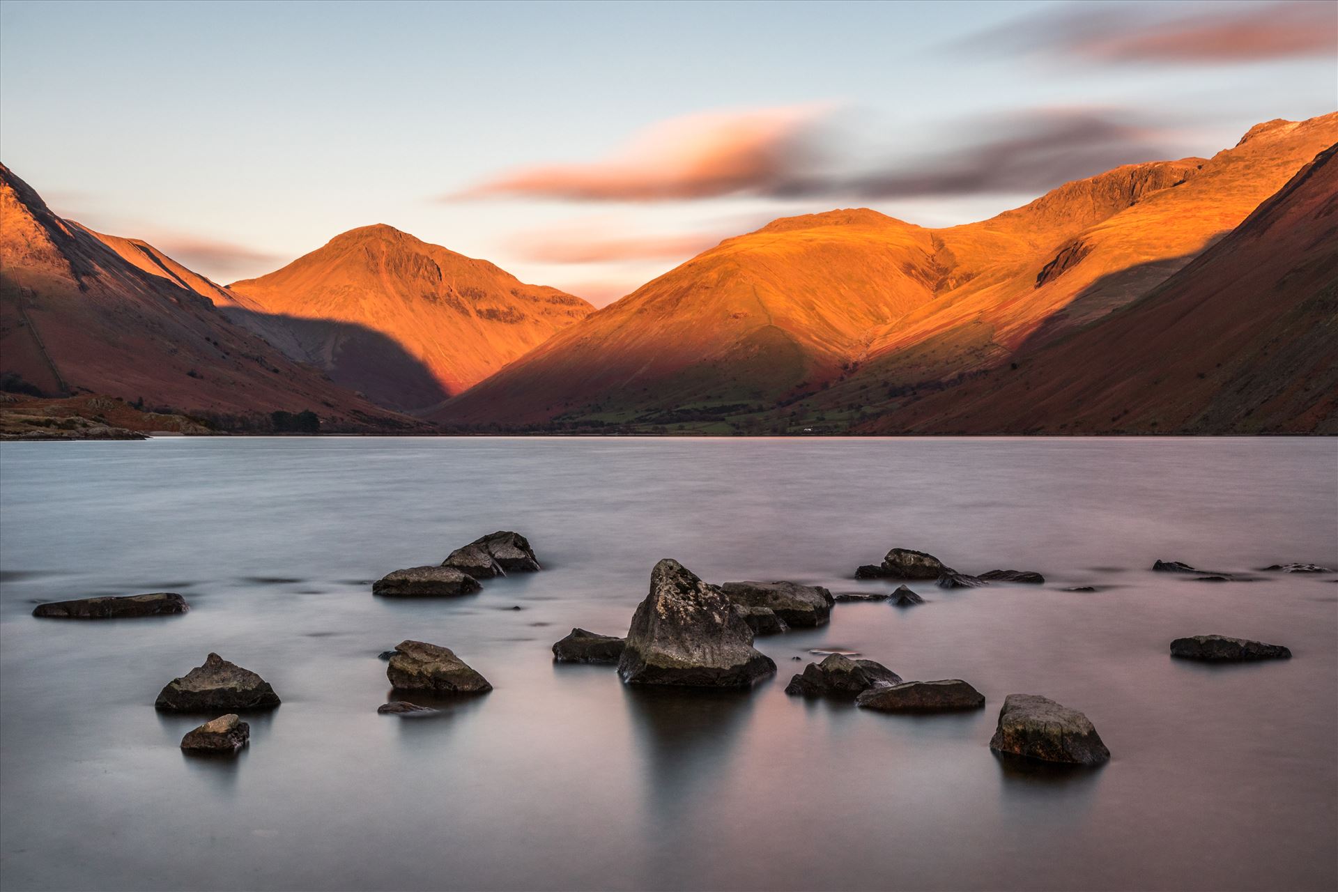 Wastwater in the Lake District Long Exposure shot of Wastwater in the Lake District looking towards Wasdale Head shortly before sunset with the mountains of Scafell, Scafell Pike and Great Gable in the distance. by Tony Keogh Photography