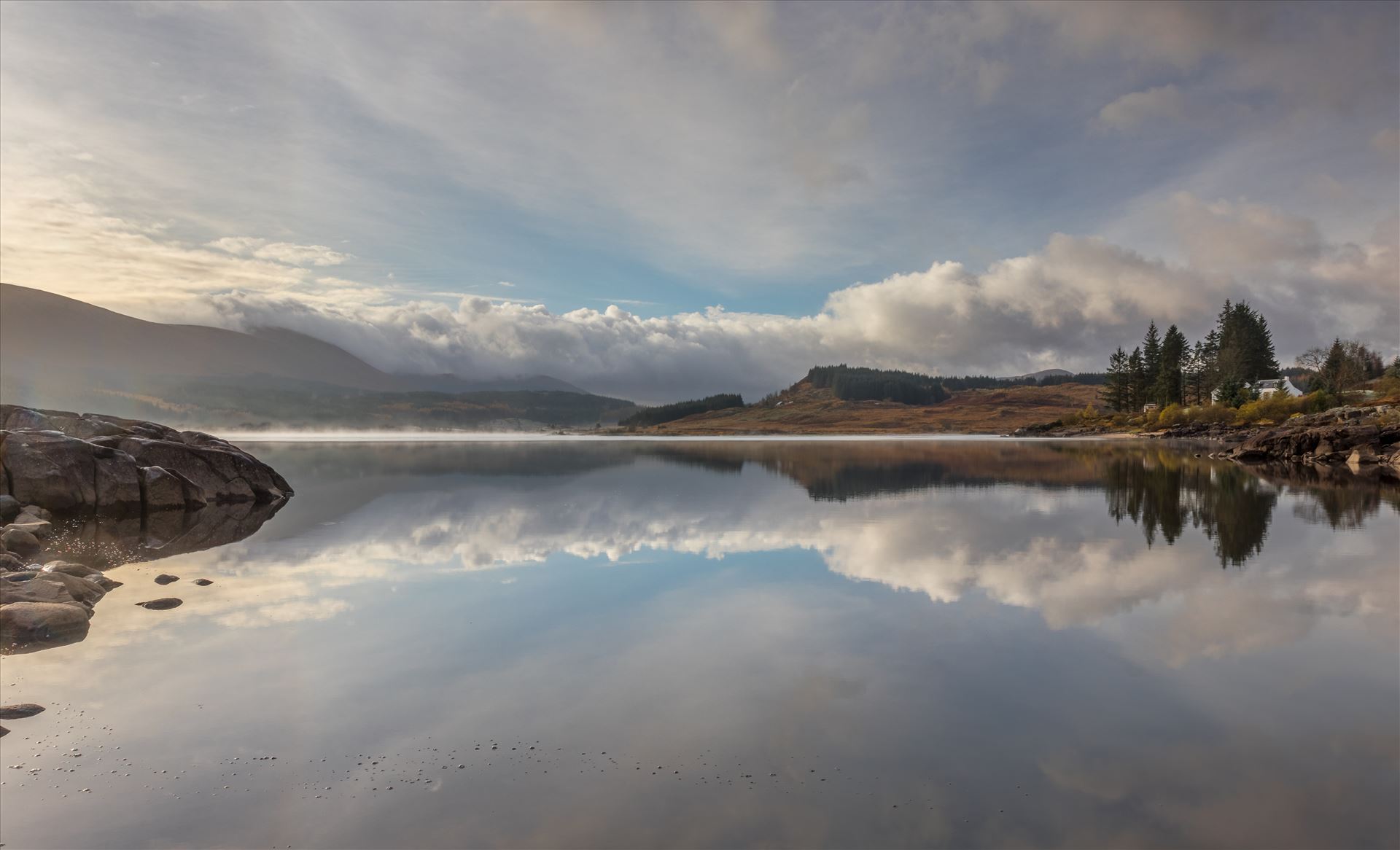 Loch Doon in the Galloway Forest Early morning mist and reflections in Loch Doon in the Galloway Forest in South West Scotland. by Tony Keogh Photography