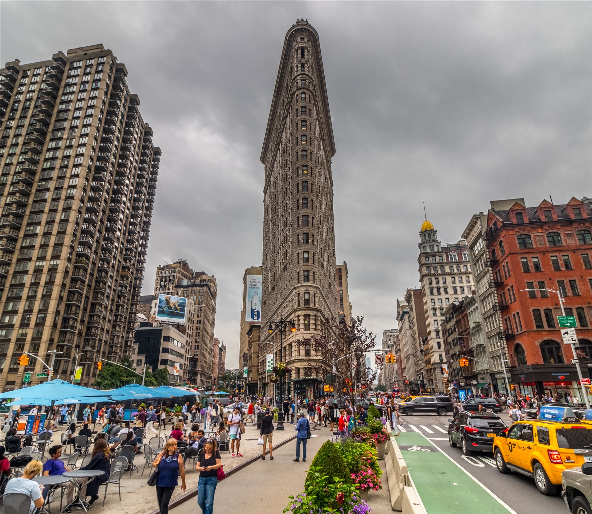 The Flatiron Building in New York The Flatiron building is one of the most iconic buildings in Manhattan in New York and is obviously named after the "iron" like shape. It was formerly the Fuller Building.  by Tony Keogh Photography