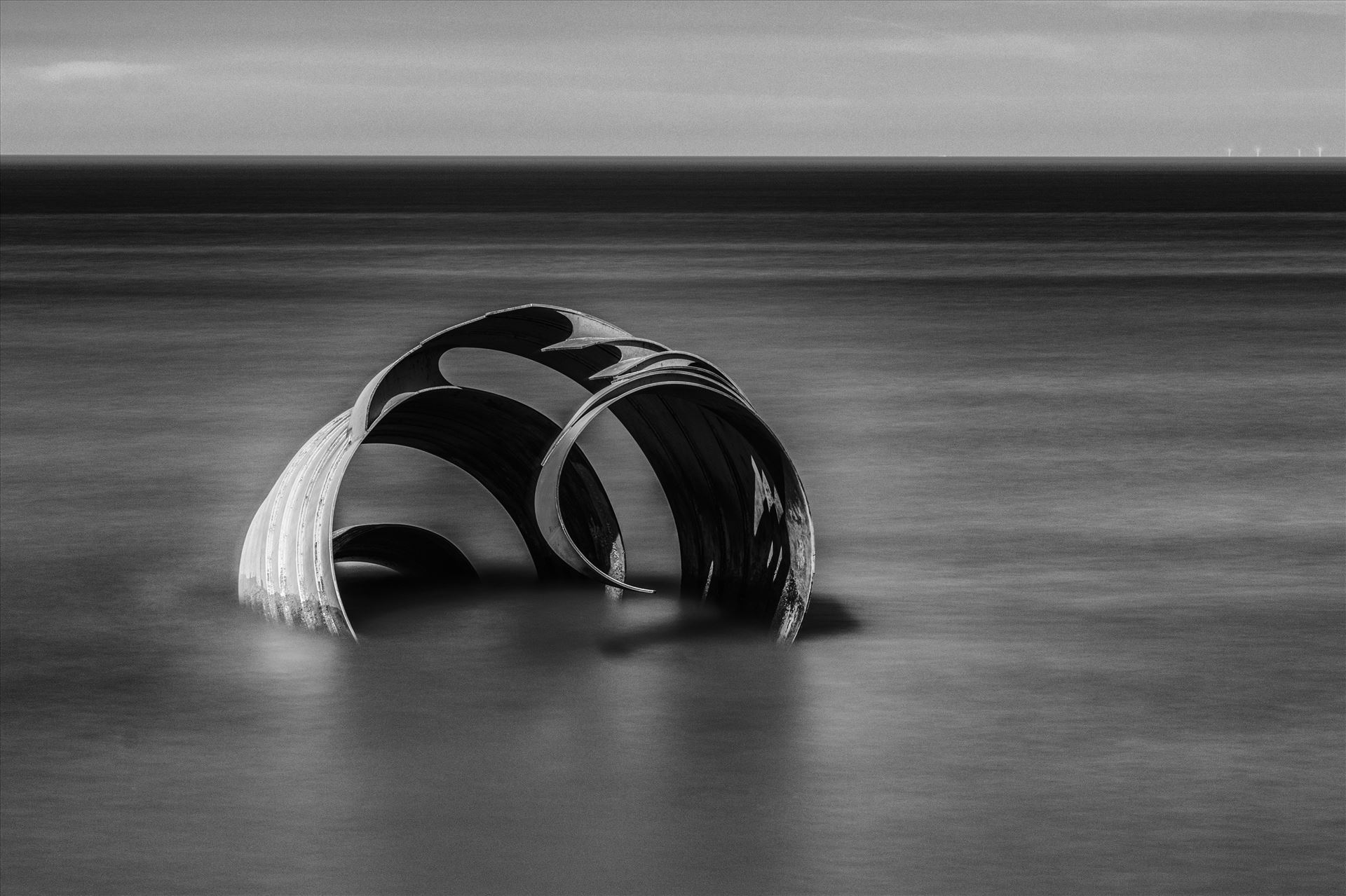 Marys Shell at Cleveleys - Mono Version The famous "Mary's Shell" is a metal sculpture on the beach at Cleveleys. The views of the sculpture vary dramatically depending on the tide. Mono Version.  by Tony Keogh Photography