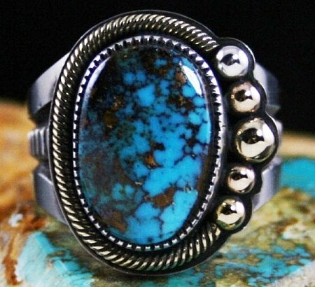 Silver Ring by Sammie Kescoli Begay: Turquoise Direct Take a look at this elegant ingot sterling silver ring available at Turquoise Direct. It is designed by Sammie Kescoli Begay and is a fine example of Native American artwork. The Candelaria spiderweb turquoise stone adorn the centre place in the ring. by Turquoisedirect