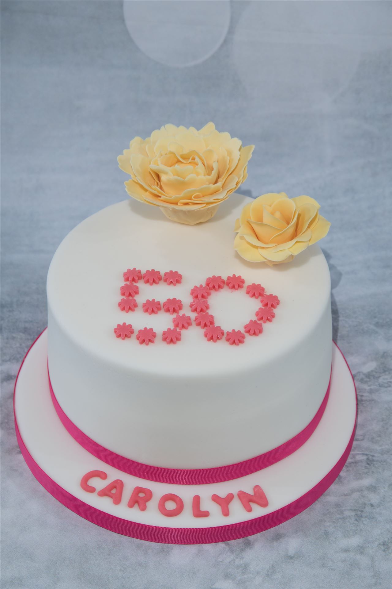 . I made this cake for a family members' 50th birthday recently. 3 layers of light and moist vanilla sponge sandwiched together with lashings of raspberry jam and creamy raspberry ripple buttercream. The flowers are hand crafted using flower paste. by Alison Wonderland Bakes