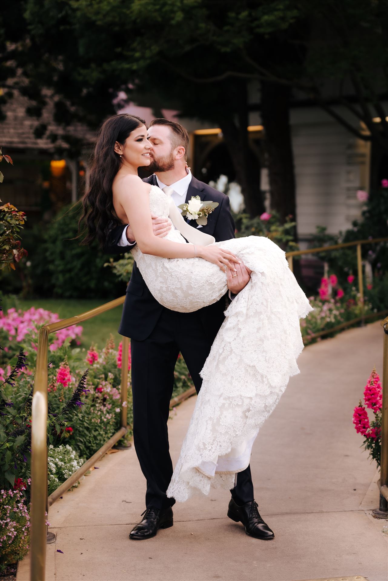 SP Gallery-5906.JPG Mirror's Edge Photography captures Xochitl and David's magical Madonna Inn Wedding in San Luis Obispo, California. Groom carries Bride in front of Madonna Inn Restaurant. by Sarah Williams
