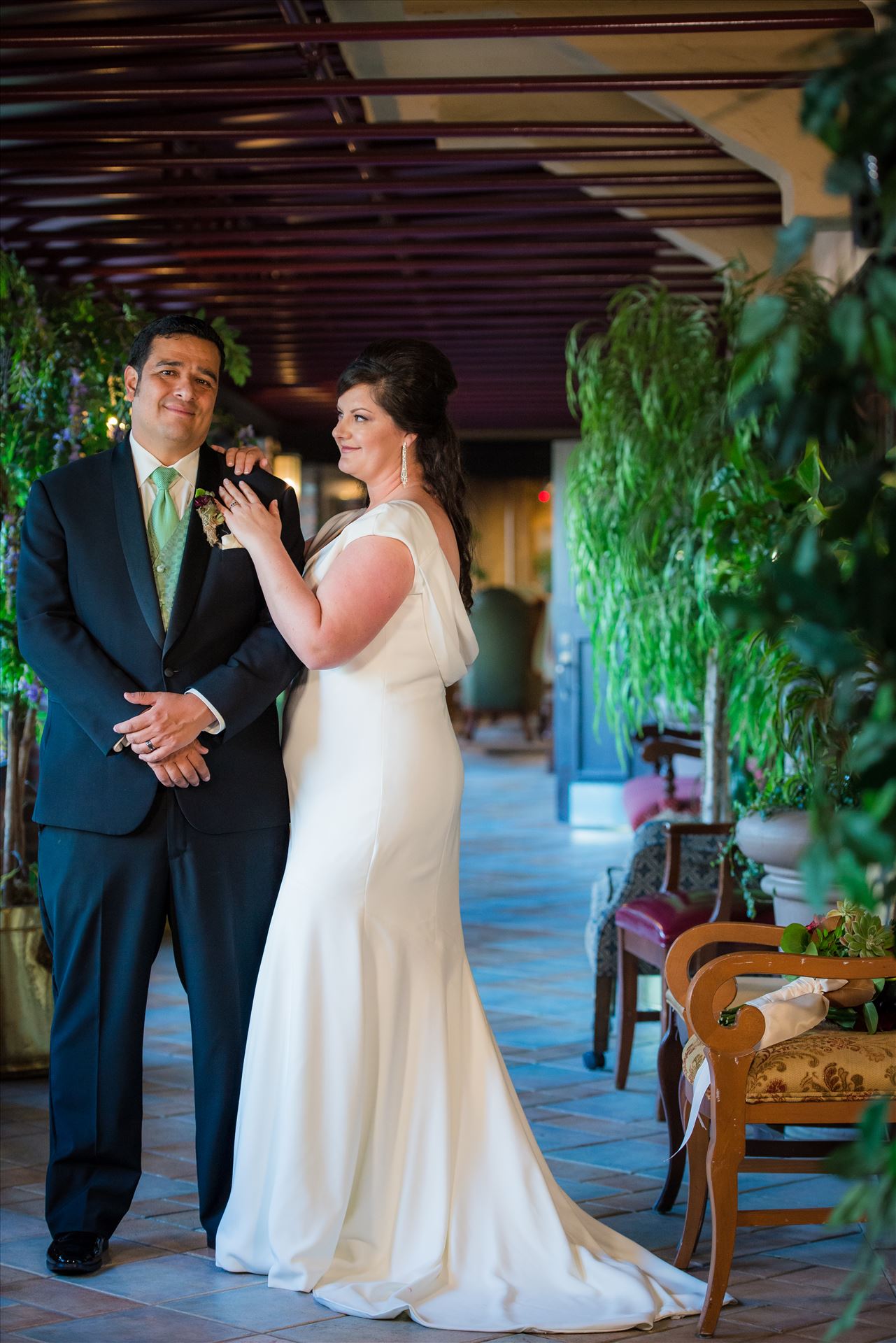 Mary and Alejandro 15 Wedding photography at the Historic Santa Maria Inn in Santa Maria, California by Mirror's Edge Photography. Bride and Groom in breezeway between the Taproom and the Front Desk at the Santa Maria Inn. by Sarah Williams