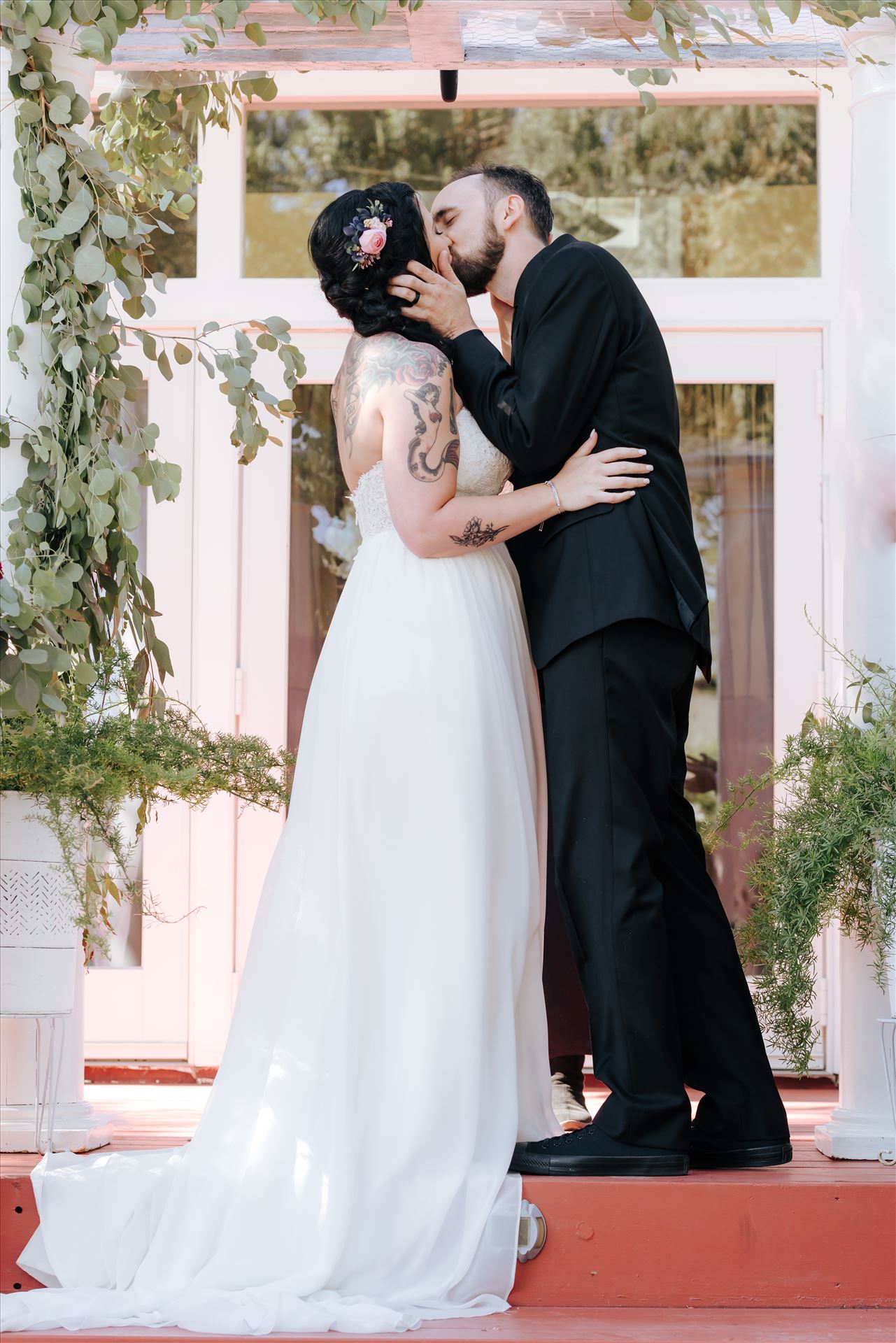 Kendra and Mitchell 062 Emily House Bed and Breakfast Paso Robles California Wedding Photography by Mirrors Edge Photography.  Bride and Groom kiss by Sarah Williams