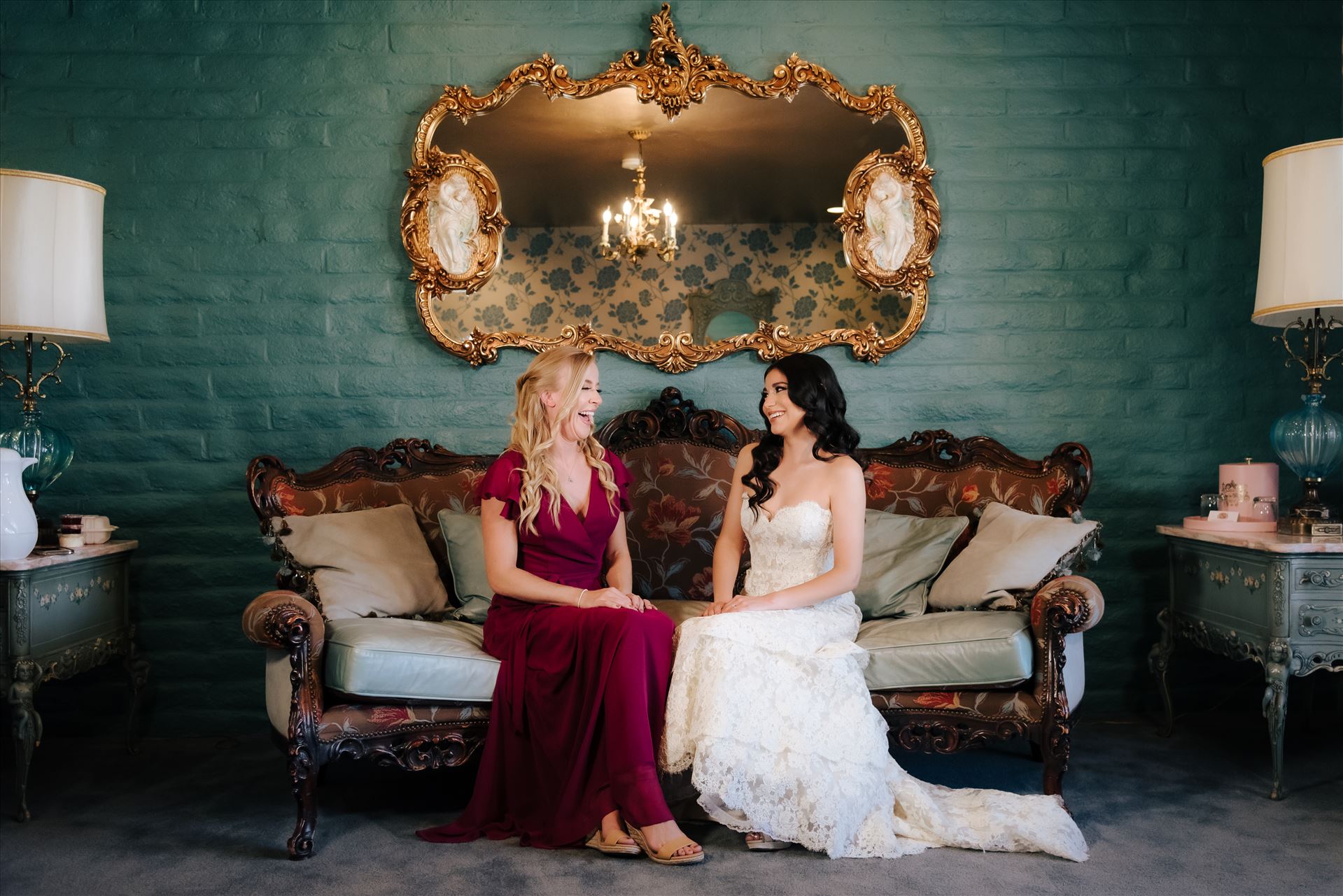 SP Gallery-1279.JPG Mirror's Edge Photography captures Xochitl and David's magical Madonna Inn Wedding in San Luis Obispo, California. Bride and Bridesmaid in the Romance Suit on the couch. by Sarah Williams