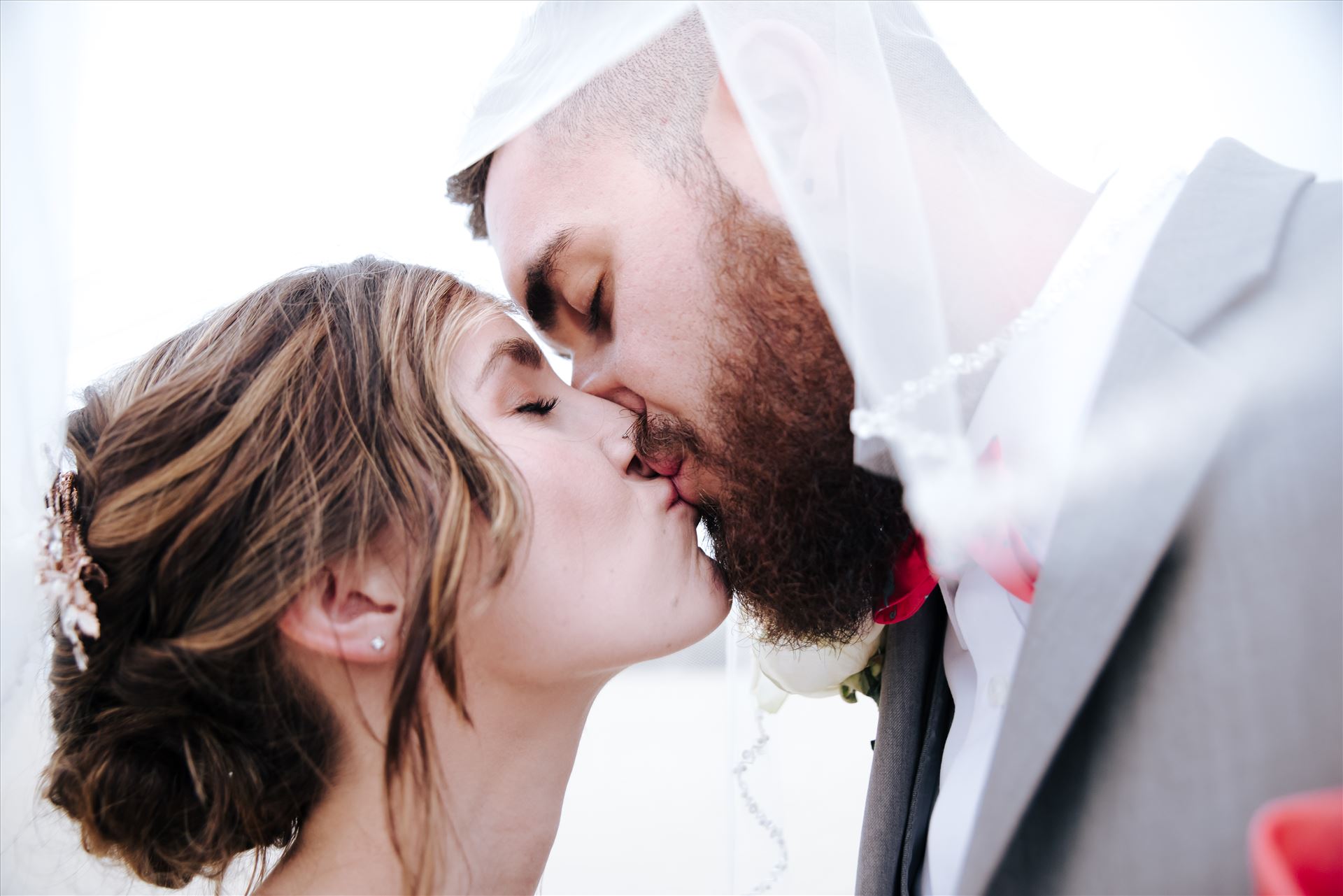 FW-9090.jpg Romantic wedding in the sand on Grover Beach in California.  Barefoot with surfboards and driftwood, tent and ceremony set up by Beach Butlerz, wedding photography by Mirror's Edge Photography.  Romantic Bride and Groom under the veil by Sarah Williams