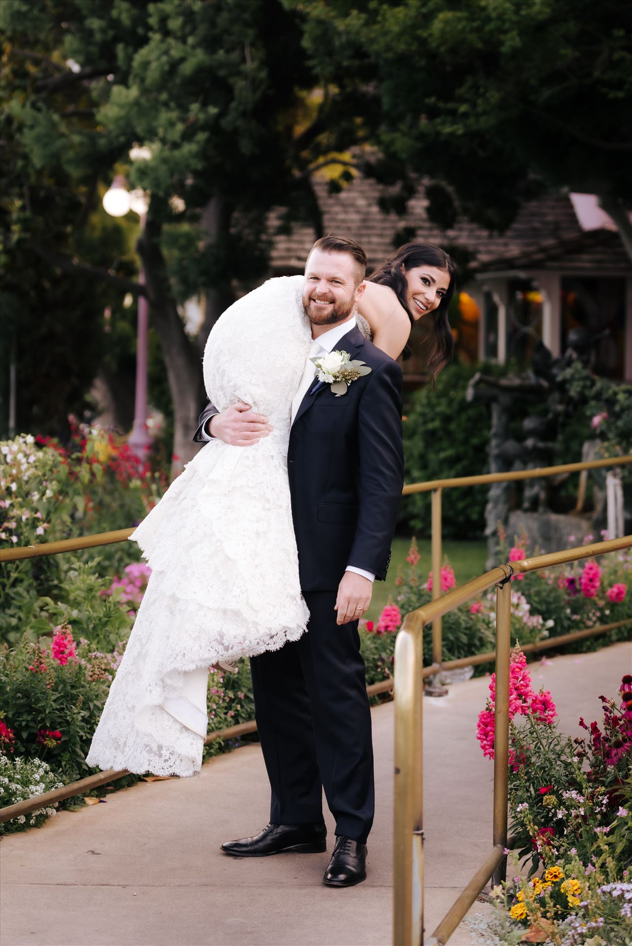 SP Gallery-5878.JPG Mirror's Edge Photography captures Xochitl and David's magical Madonna Inn Wedding in San Luis Obispo, California. Groom carries away his Bride in front of the Madonna Inn Restaurant. by Sarah Williams