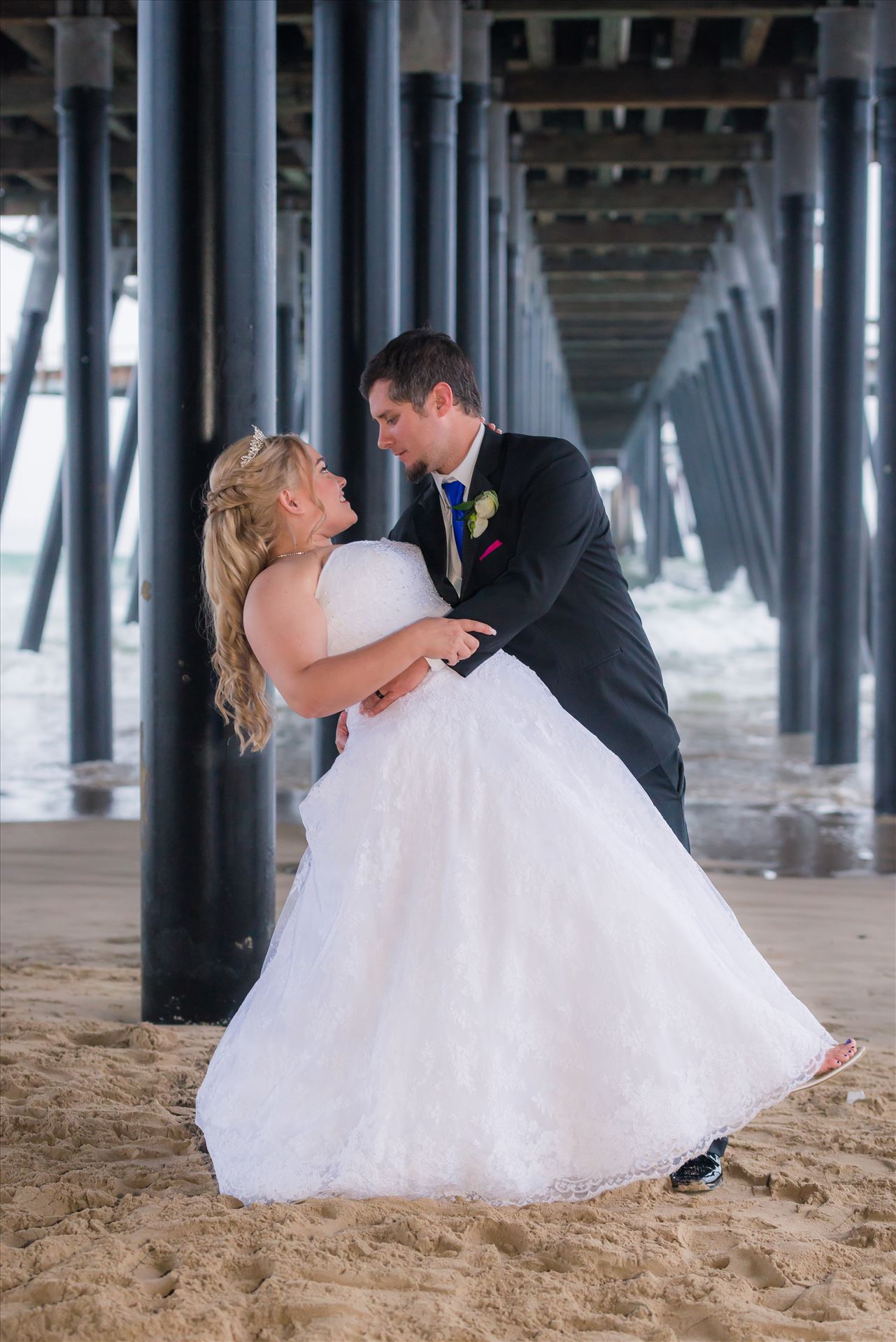 Jessica and Michael 69 Sea Venture Resort and Spa Wedding Photography by Mirror's Edge Photography in Pismo Beach, California. Bride and Groom under Pismo Beach Pier by Sarah Williams