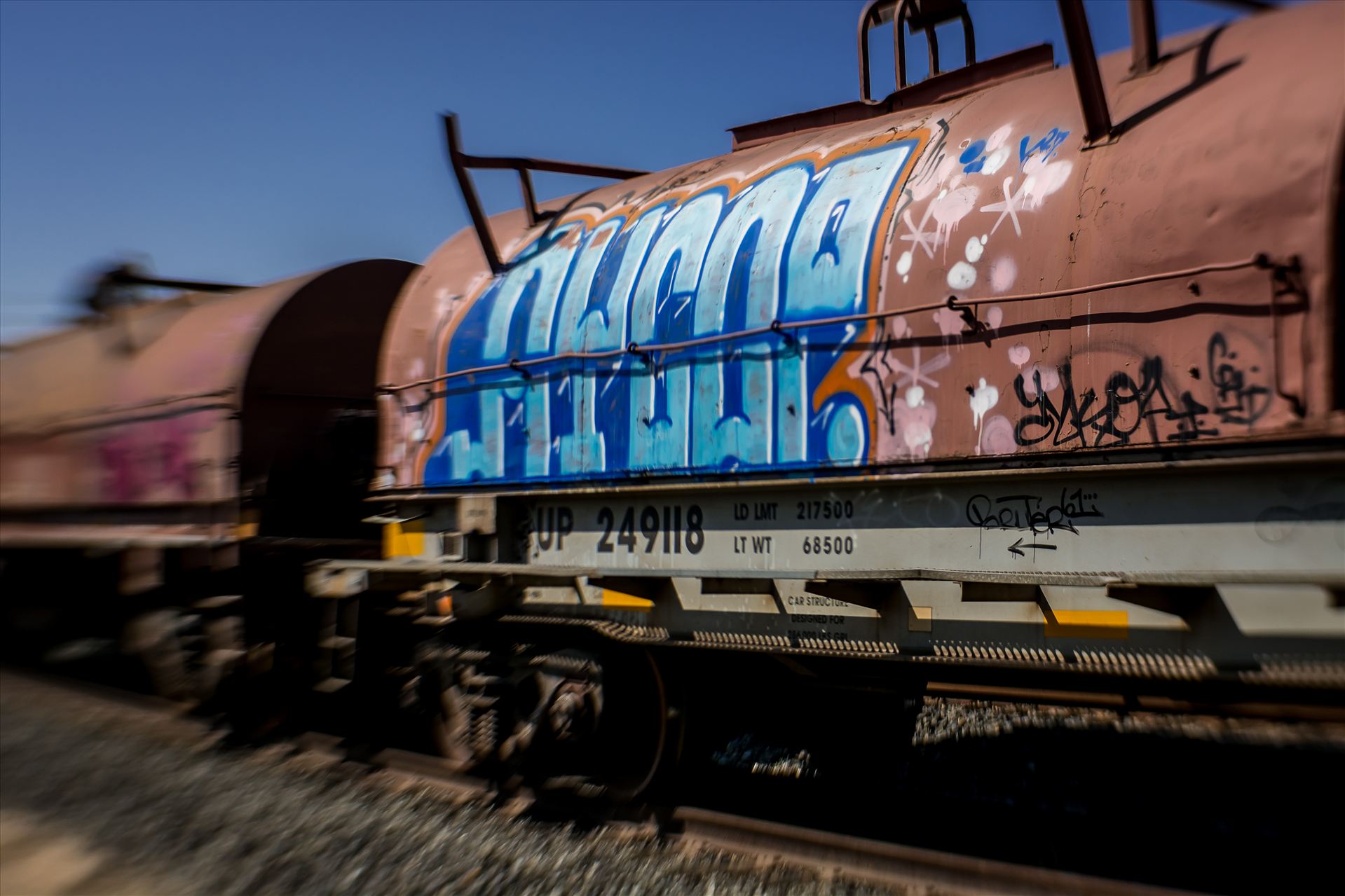 Graffiti Tankers 2.jpg Colorful urban artwork on oil tankers on train tracks by Sarah Williams