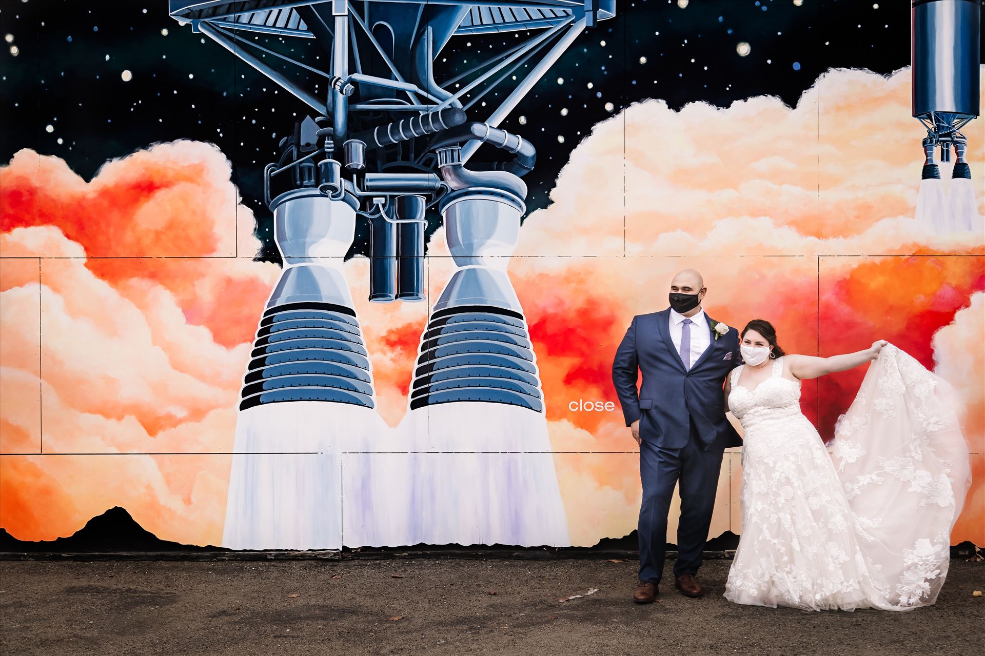 FW-3467.JPG Sarah Williams of Mirror's Edge Photography and San Luis Obispo and Santa Barbara Wedding Photographer captures the Ochoa Wedding. Bride and Groom with Covid 19 Masks at Rocket Mural in Lompoc California. by Sarah Williams