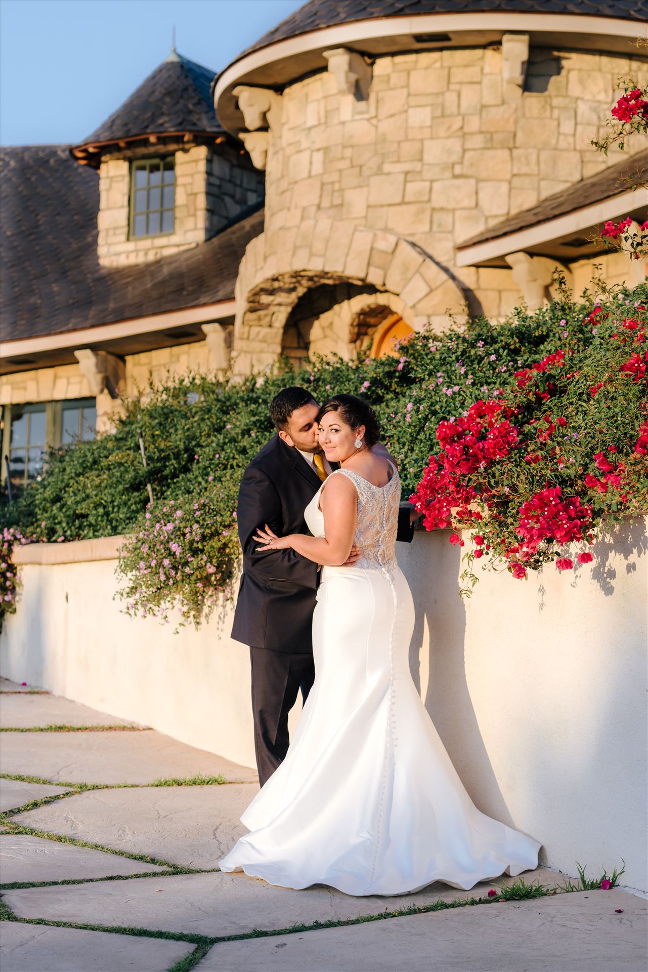 Victoria and Esteban 147 Sarah Williams of Mirror's Edge Photography captures the gorgeous fairy tale wedding day of Victoria and Esteban at the Castle Noland Wedding Venue in San Luis Obispo, California.  Bride and Groom at sunset in front of Castle Noland romatic by Sarah Williams
