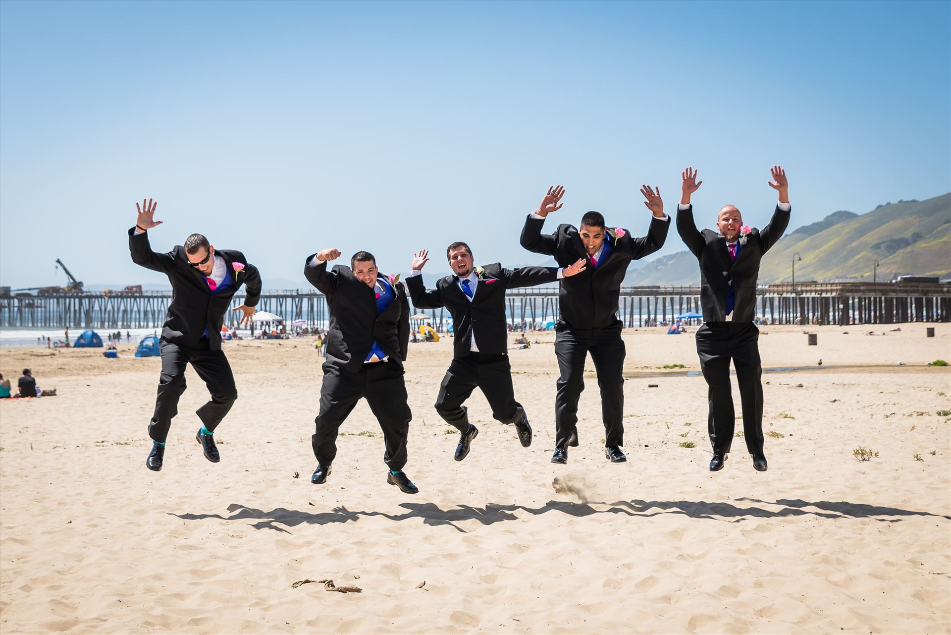Jessica and Michael 20 Sea Venture Resort and Spa Wedding Photography by Mirror's Edge Photography in Pismo Beach, California. Groom and Groomsmen jumping by Sarah Williams