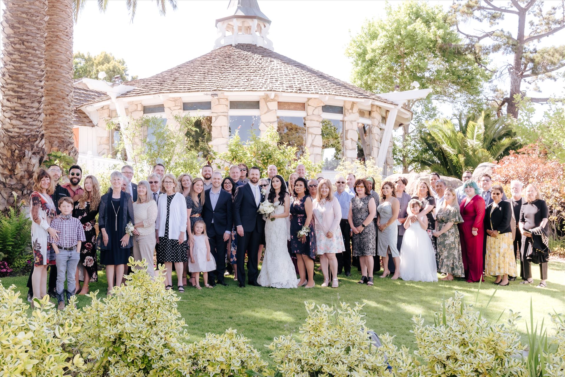 SP Gallery-1325.JPG Mirror's Edge Photography captures Xochitl and David's magical Madonna Inn Wedding in San Luis Obispo, California. The entire family in front of the Round Room, group photo Bride and Groom and family. by Sarah Williams