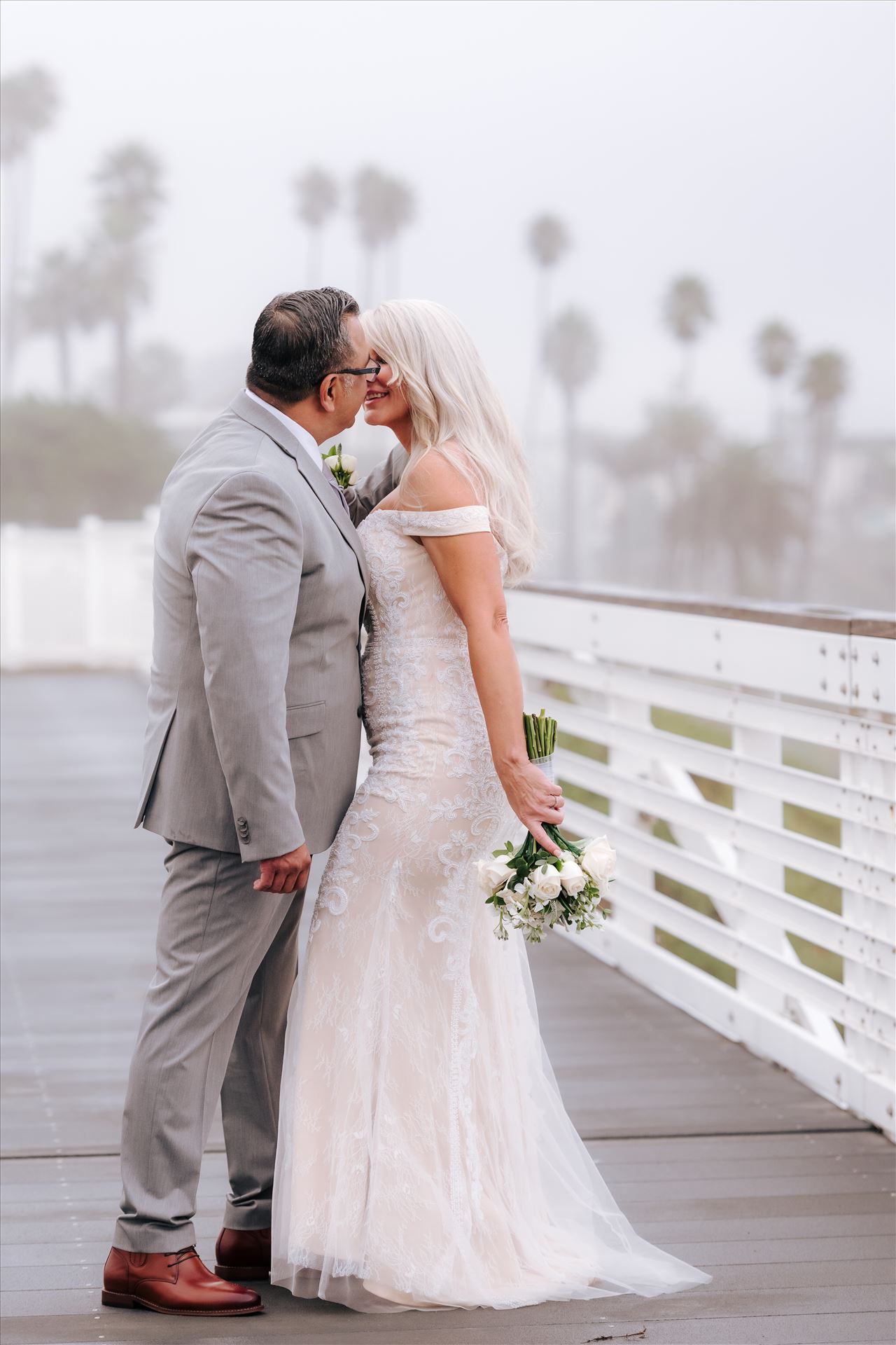 Final-7574.jpg Rainy day wedding at the Shore Cliff Hotel Gazebo in Pismo Beach, California in San Luis Obispo County by Mirror's Edge Photography.  Misty and rainy Bride and Groom kissing on the boardwalk in Pismo Beach California. by Sarah Williams