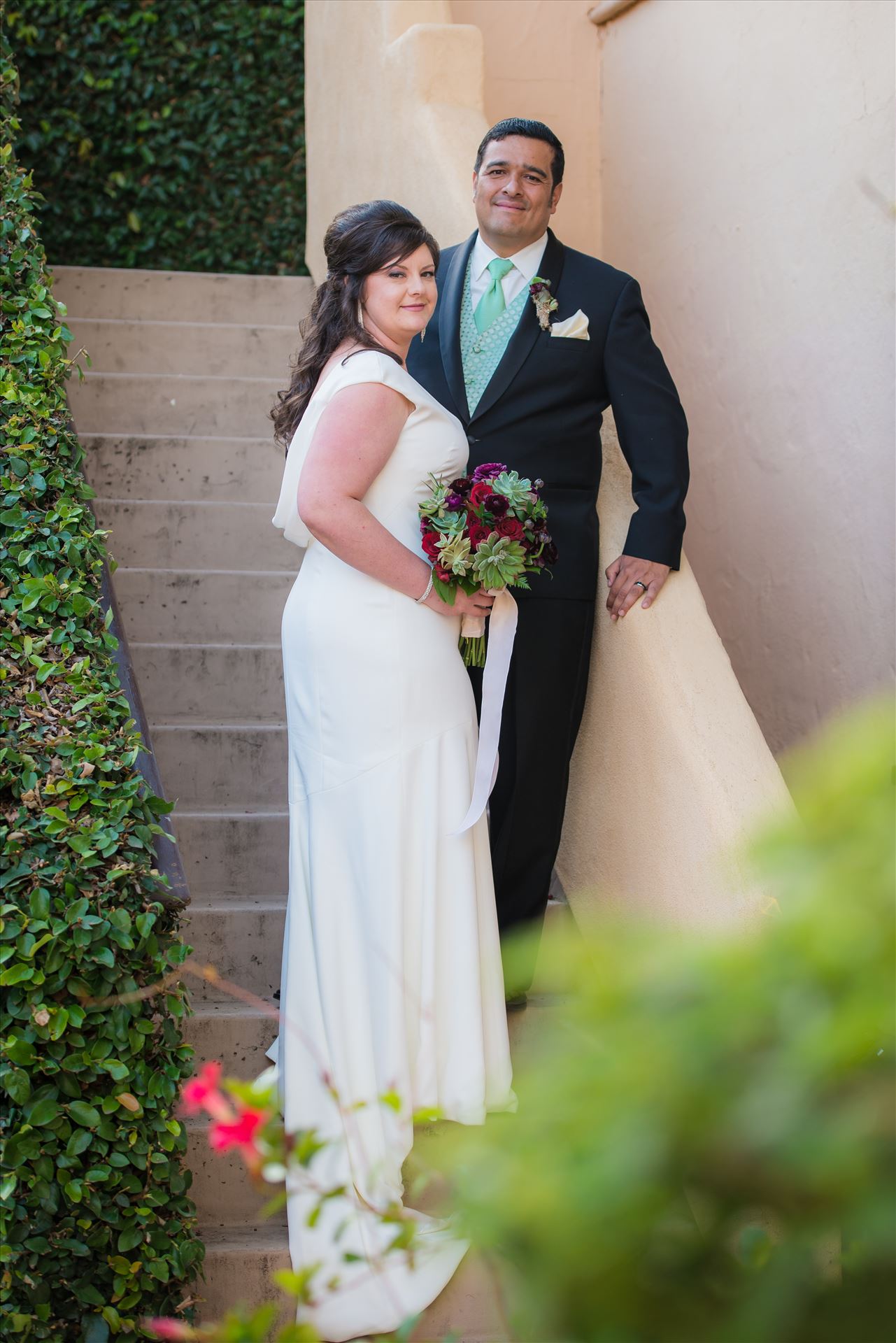 Mary and Alejandro 16 Wedding photography at the Historic Santa Maria Inn in Santa Maria, California by Mirror's Edge Photography. Bride and Groom on the Ivy Staircase after Ceremony. by Sarah Williams