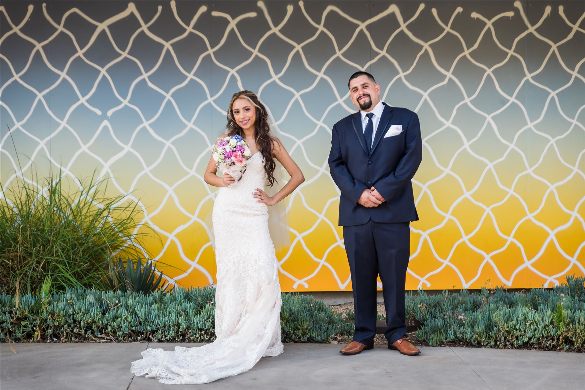Ana and Juan 65 Wedding photography at the Kimpton Goodland Hotel in Santa Barbara California by Mirror's Edge Photography.  Bride and Groom by Retro Art Wall by Sarah Williams