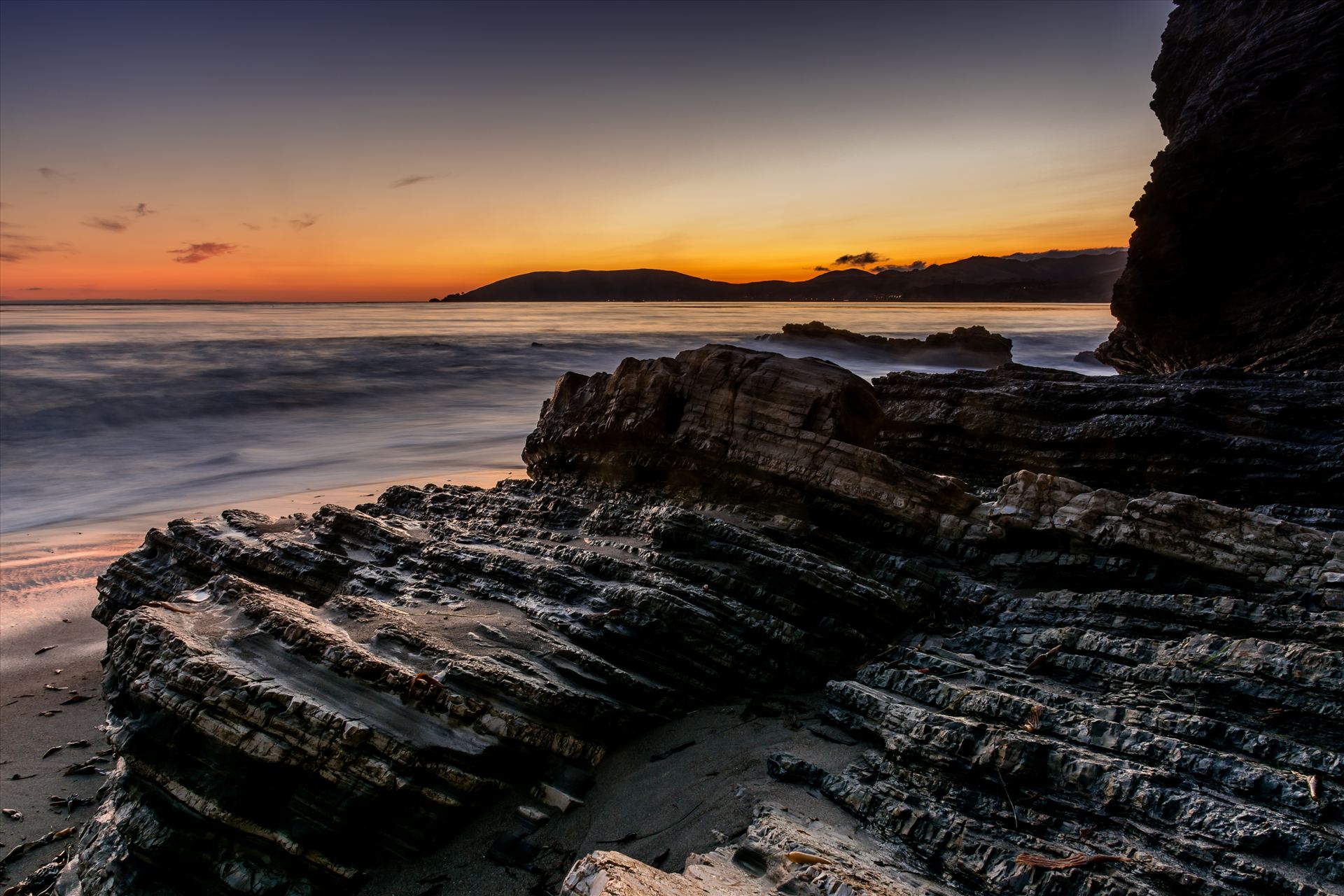Avila in the Distance.jpg Spyglass cliffs at sunset with Avila Beach in the distance by Sarah Williams