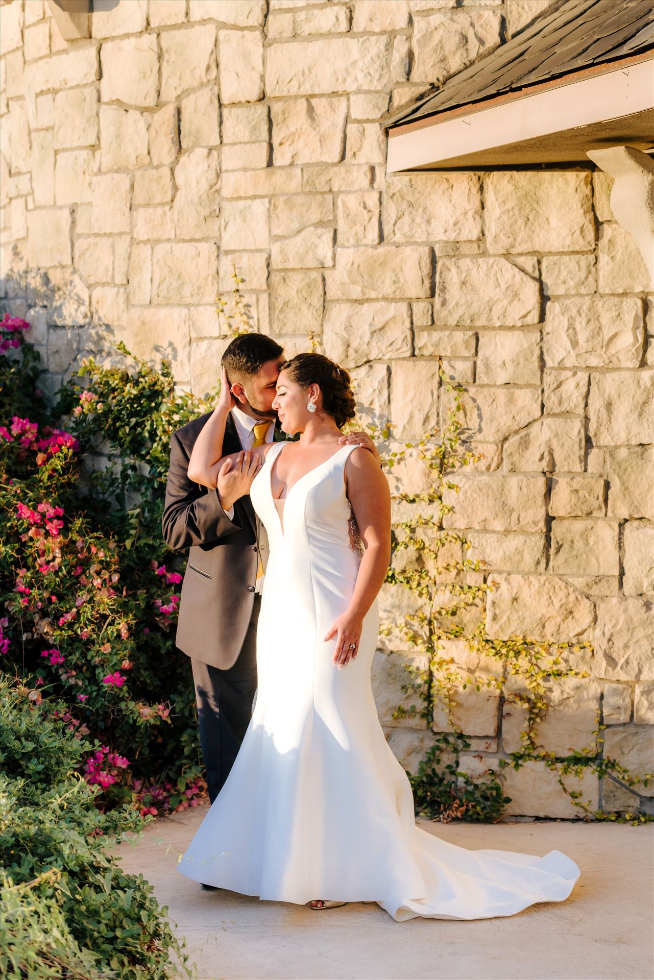 Victoria and Esteban 145 Sarah Williams of Mirror's Edge Photography captures the gorgeous fairy tale wedding day of Victoria and Esteban at the Castle Noland Wedding Venue in San Luis Obispo, California.  Bride and Groom at sunset in front of the castle by Sarah Williams