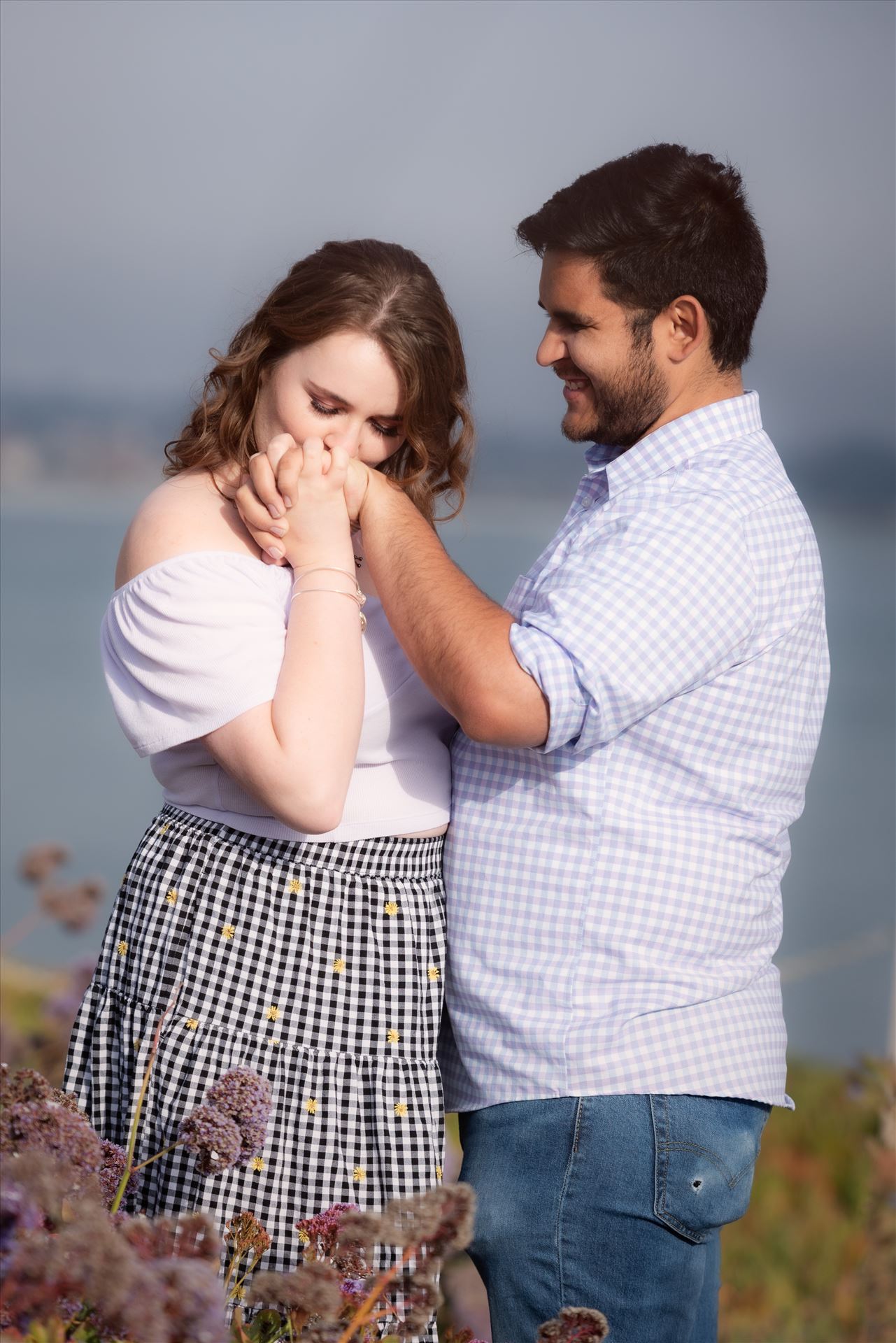 Final-75.JPG Sarah Williams of Mirror's Edge Photography, a San Luis Obispo Wedding and Engagement Photographer, captures Kara-Leigh and Deaven's amazing Engagement Photography Session at the Dinosaur Caves Park in Pismo Beach California. Girl kisses hand. by Sarah Williams