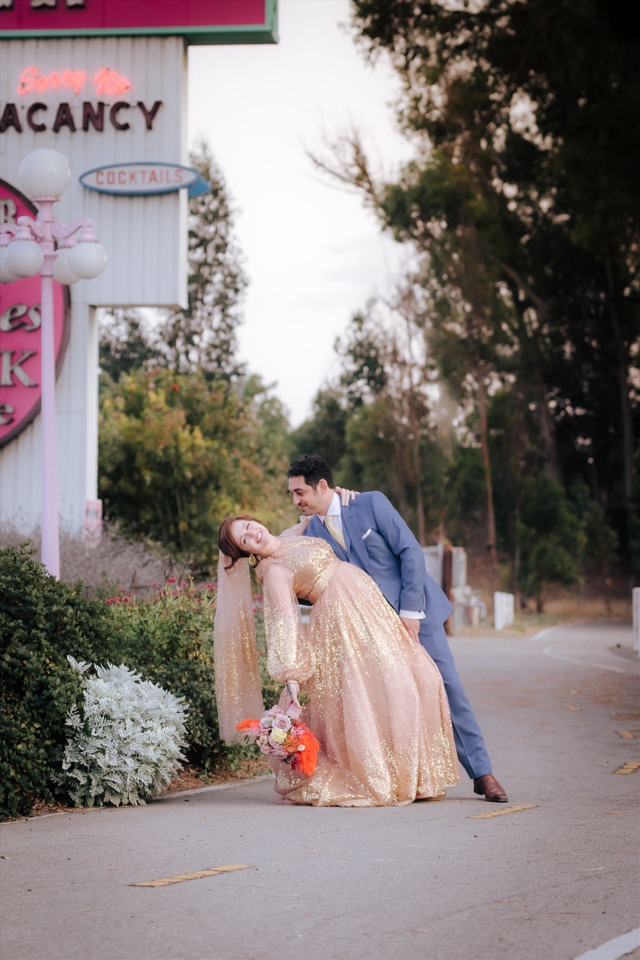 Final-0053.JPG A gorgeous Madonna Inn Wedding by Mirror's Edge Photography a San Luis Obispo Wedding and Engagement Photographer.  Bride and Groom at sunset by Madonna Inn Sign.  70's theme wedding by Sarah Williams