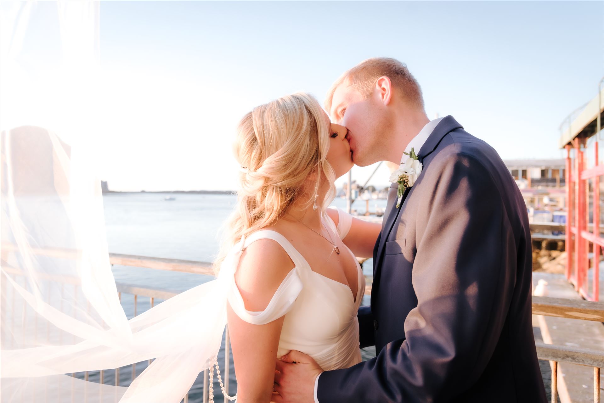 FW-9774.JPG Sarah Williams of Mirror's Edge Photography, a San Luis Obispo Wedding and Engagement Photographer, captures Ryan and Joanna's wedding at the iconic Windows on the Water Restaurant in Morro Bay, California.  Bride and Groom kiss with ocean in background by Sarah Williams