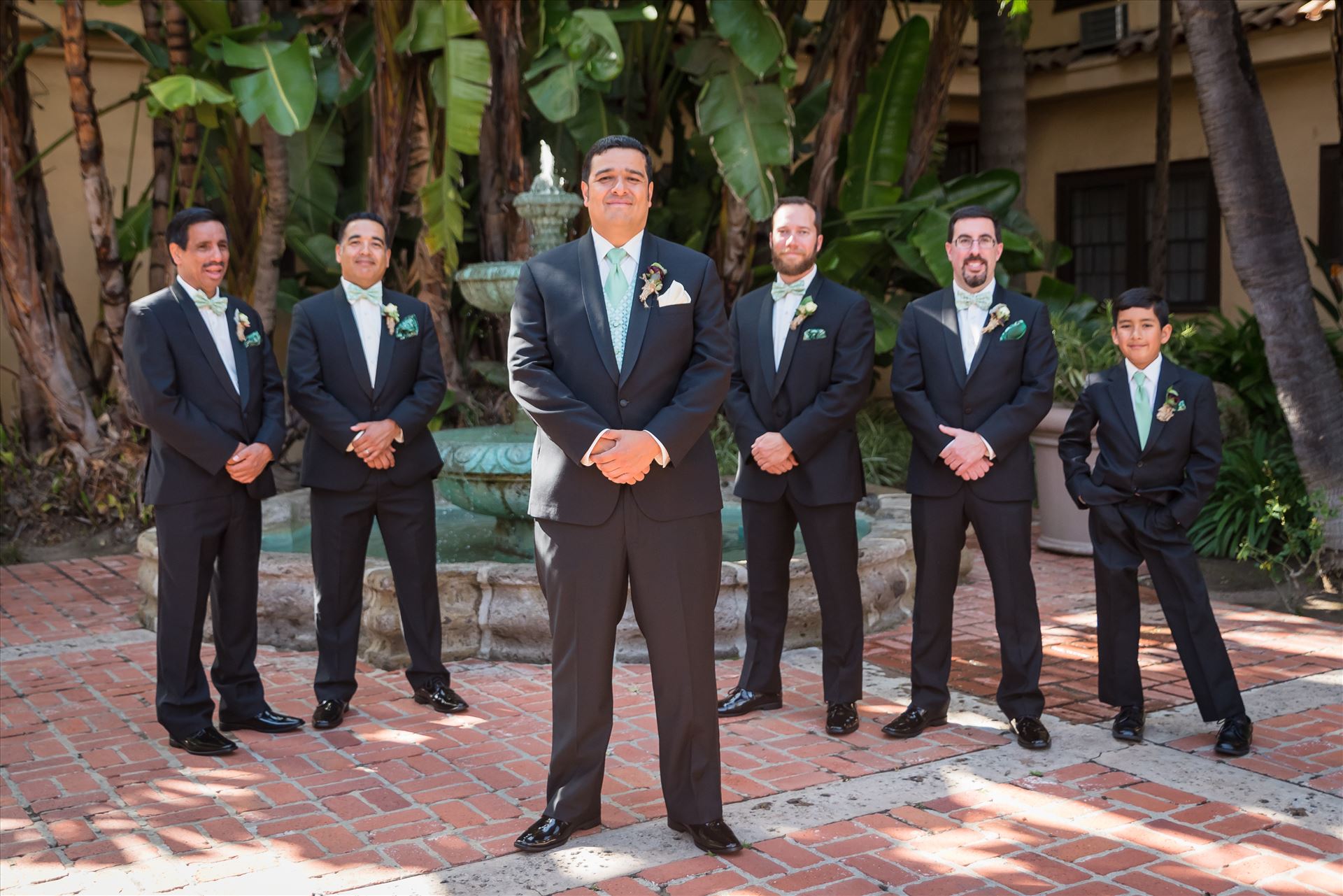 Mary and Alejandro 46 Wedding photography at the Historic Santa Maria Inn in Santa Maria, California by Mirror's Edge Photography. Groom and his groomsmen by the fountain by Sarah Williams