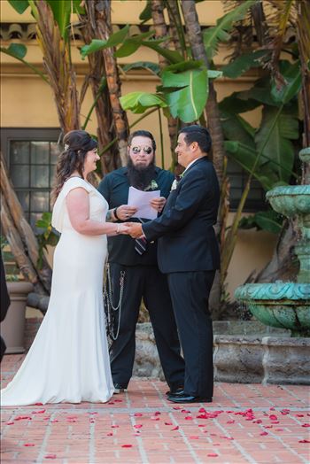 Mary and Alejandro 29 - Wedding photography at the Historic Santa Maria Inn in Santa Maria, California by Mirror\u0027s Edge Photography. Bride and Groom exchange rings in courtyard