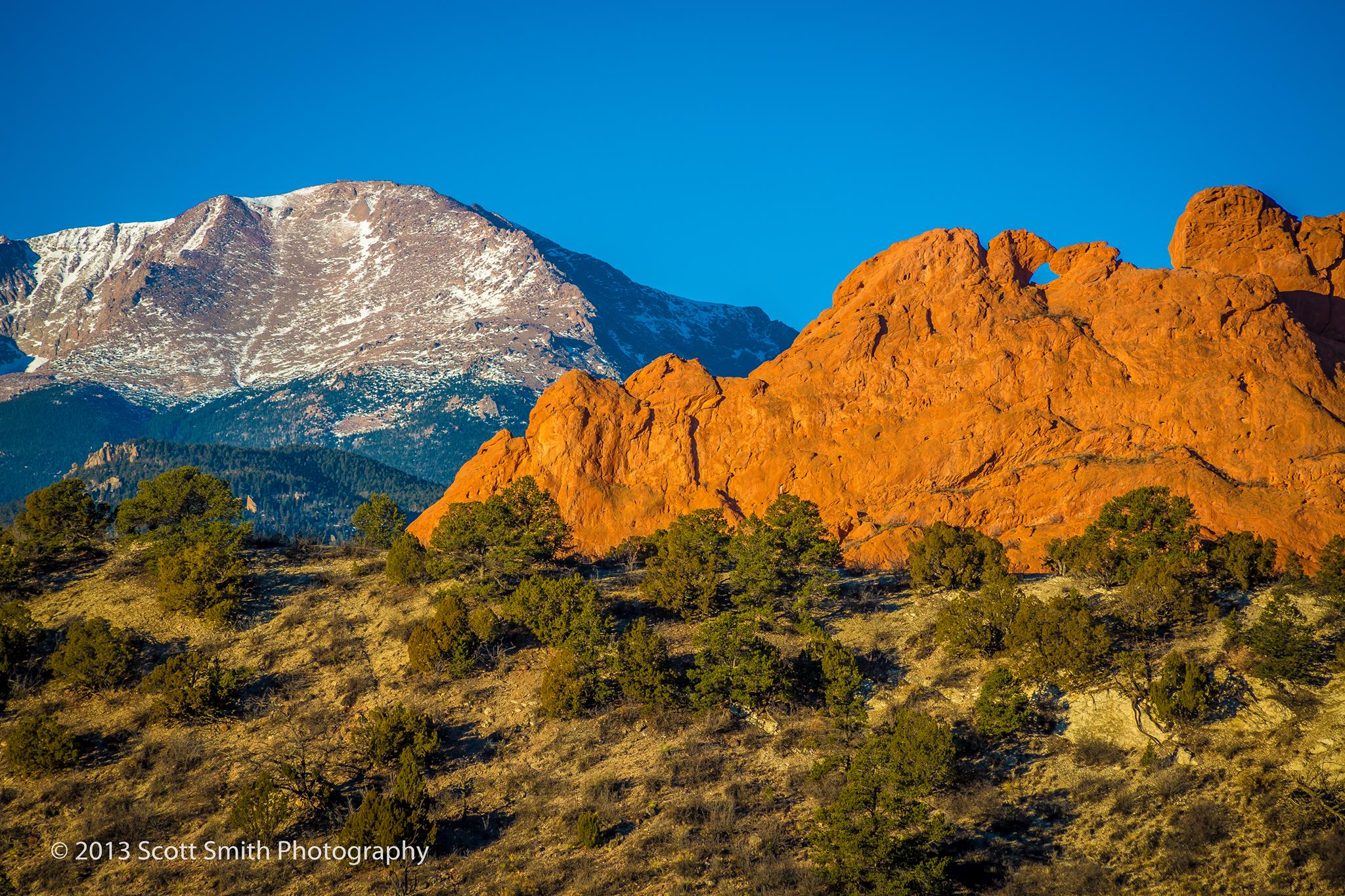 Sun rising on the Garden of the Gods The Garden of the Gods earlier in the morning with Pike's Peak in the background. by Scott Smith Photos