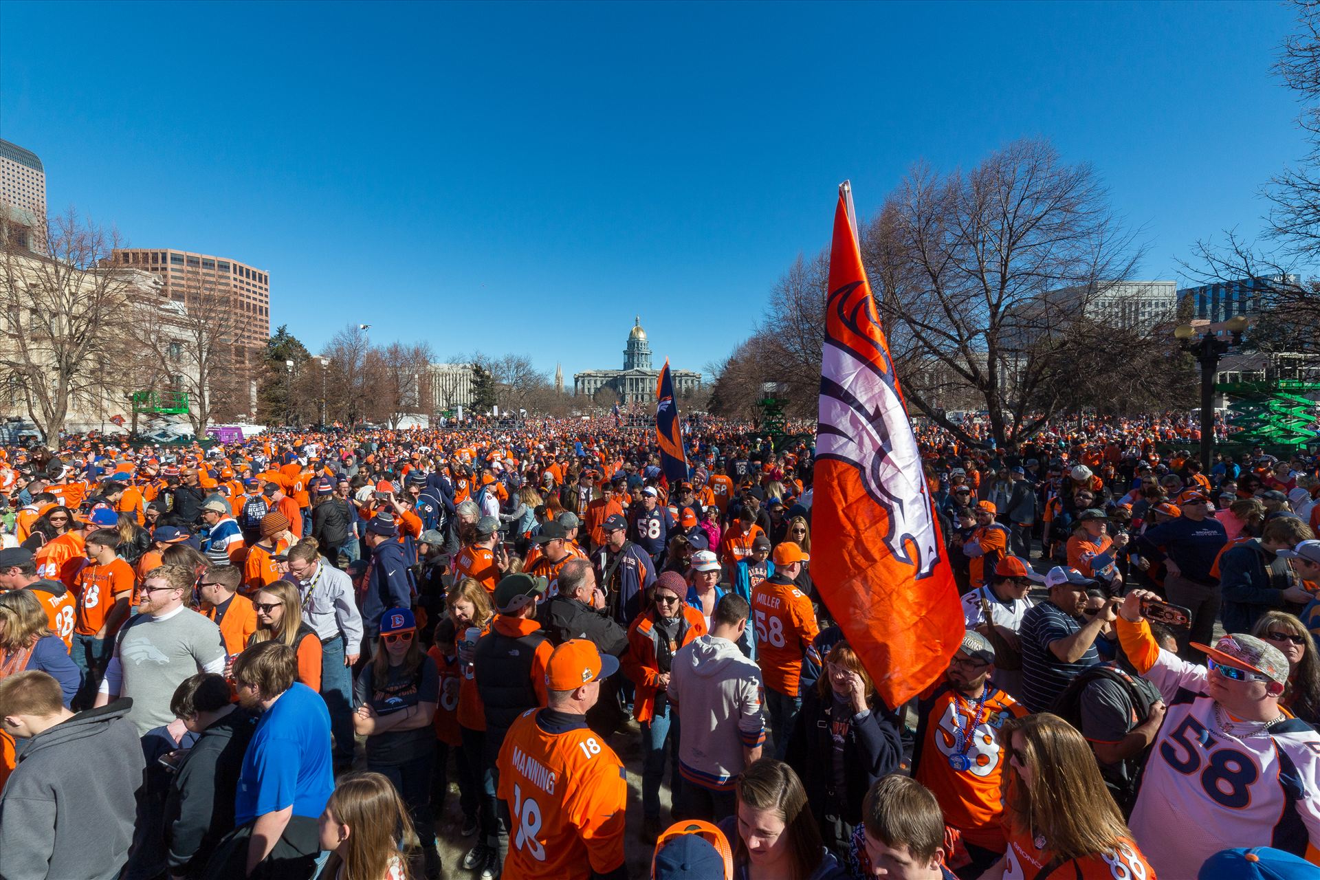 Broncos fans at Civic Park Fans of the Denver Broncos completely fill Civic Park in Denver Colorado. The state capitol building is visible in the center of the frame. by Scott Smith Photos