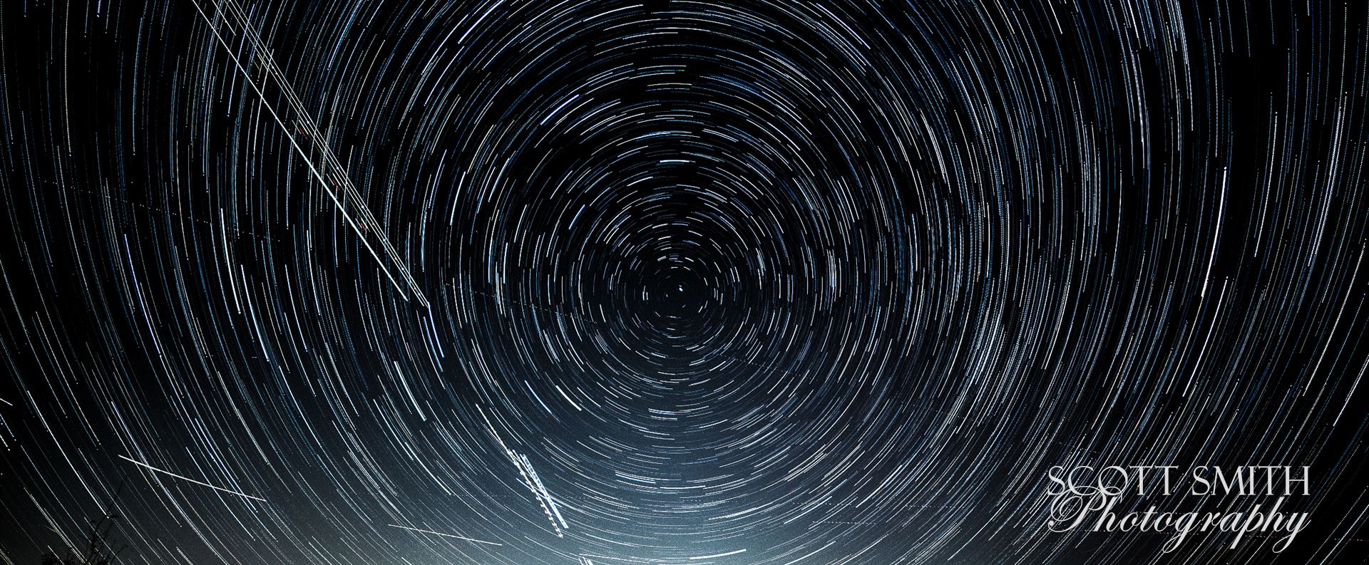 Star Trails My first attempt at shooting the Aurora Borealis, which turned out to not quite extend down to Denver tonight, turned into my first attempt at merging 103 stacked images into star trails.  The shot is cropped to remove the neighbor's house behind mine. by Scott Smith Photos