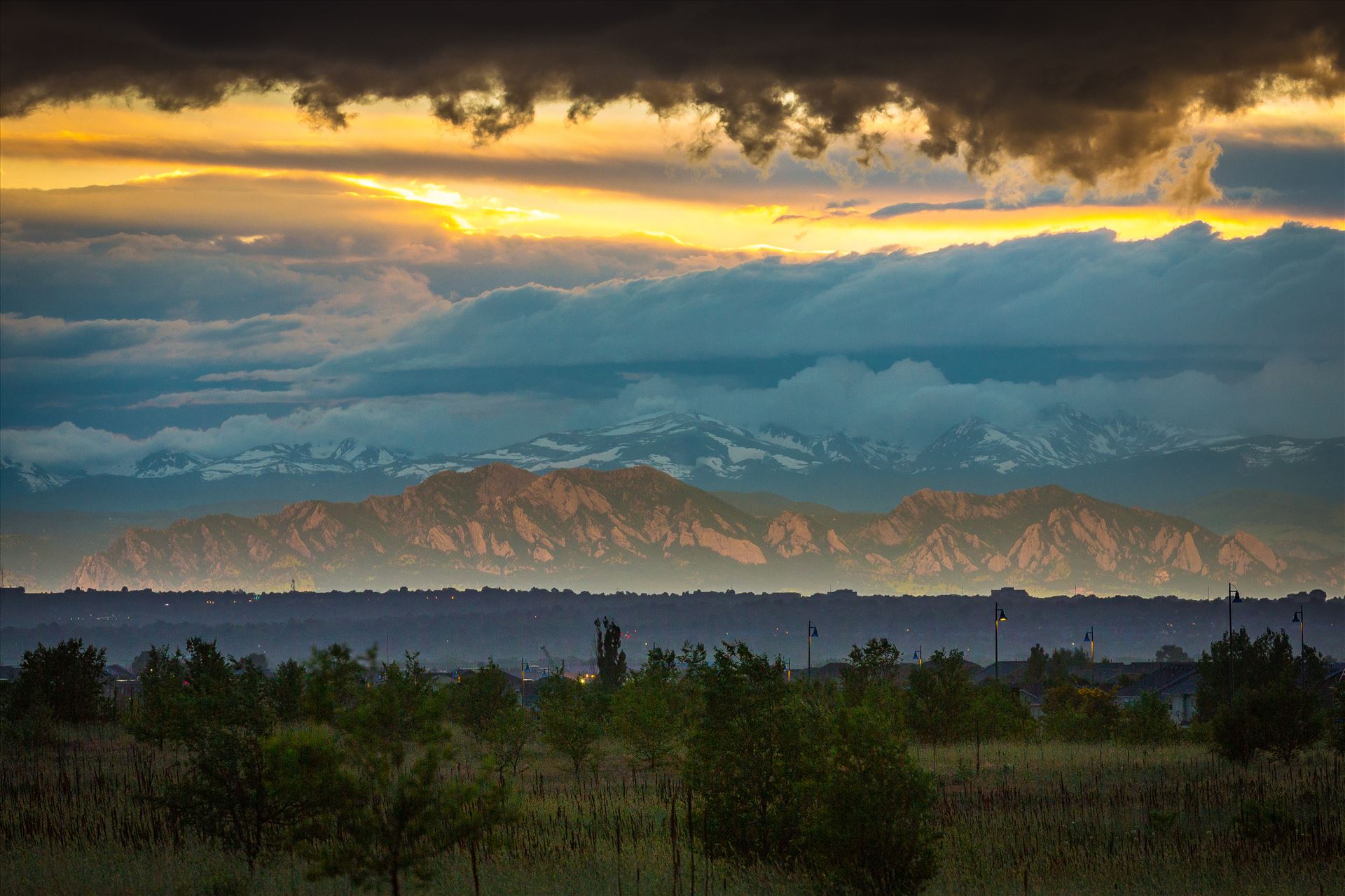 Relected Light on the Flatirons Interesting weather phenomenon as light from the setting sun reflects on a low cloud layer onto the Flatirons in Boulder, Colorado. Taken from Commerce City, Colorado. by Scott Smith Photos