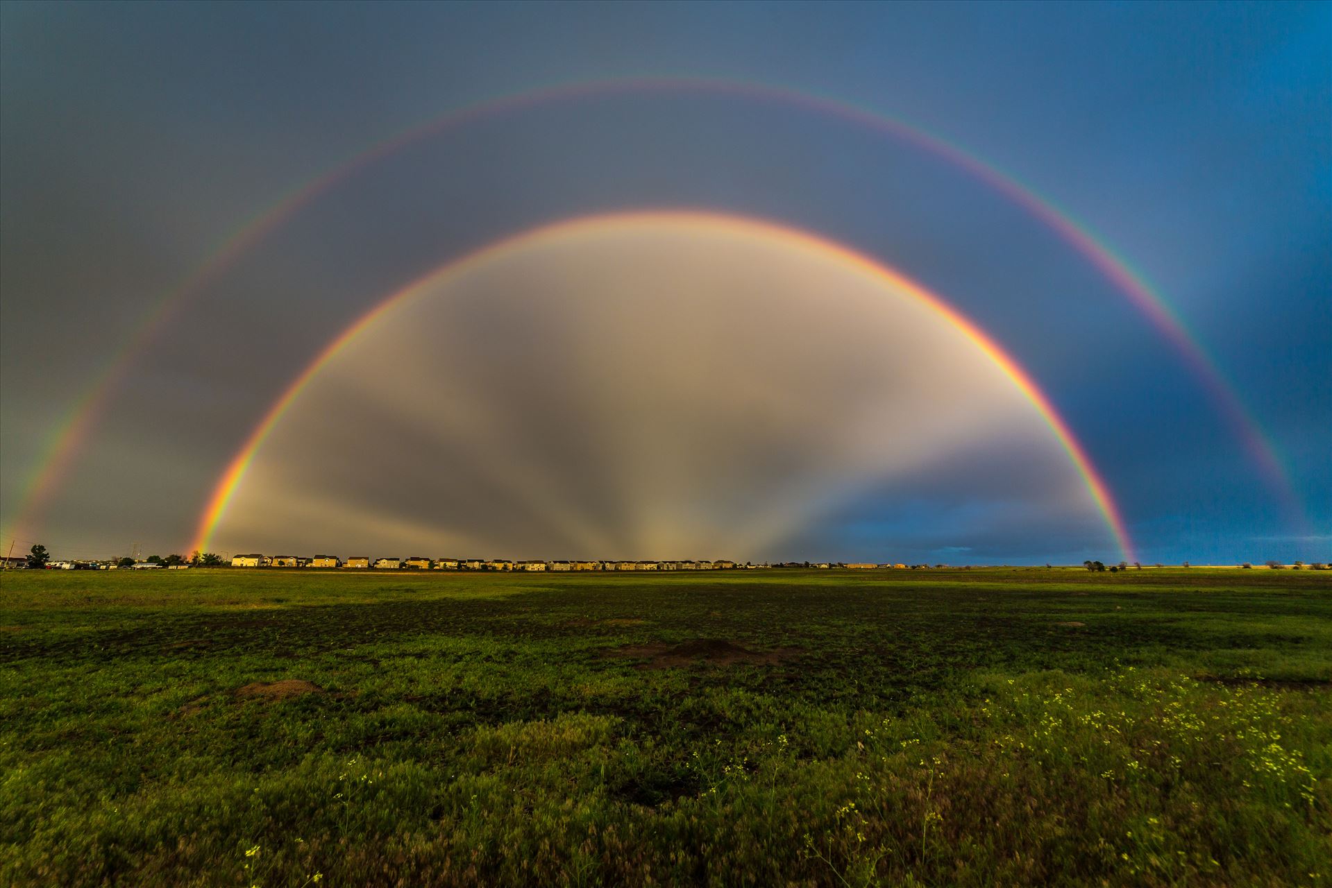 Double Rainbow with Anti-Crepuscular Rays After a hard rain and a bit of hail, anti-crepuscular rays appear to cast from the center of a double rainbow, near Reunion, Colorado. by Scott Smith Photos