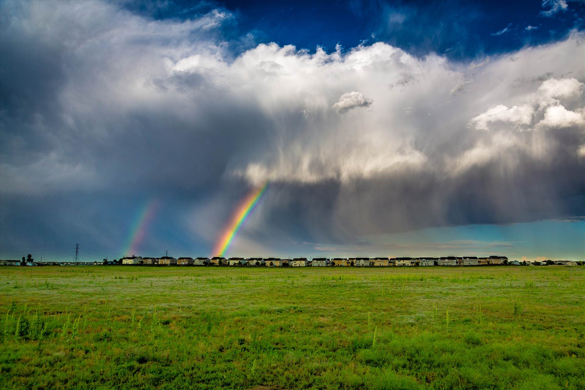 Suburbia Rainbow Connection A double rainbow breaks through some clouds east of Denver. by Scott Smith Photos