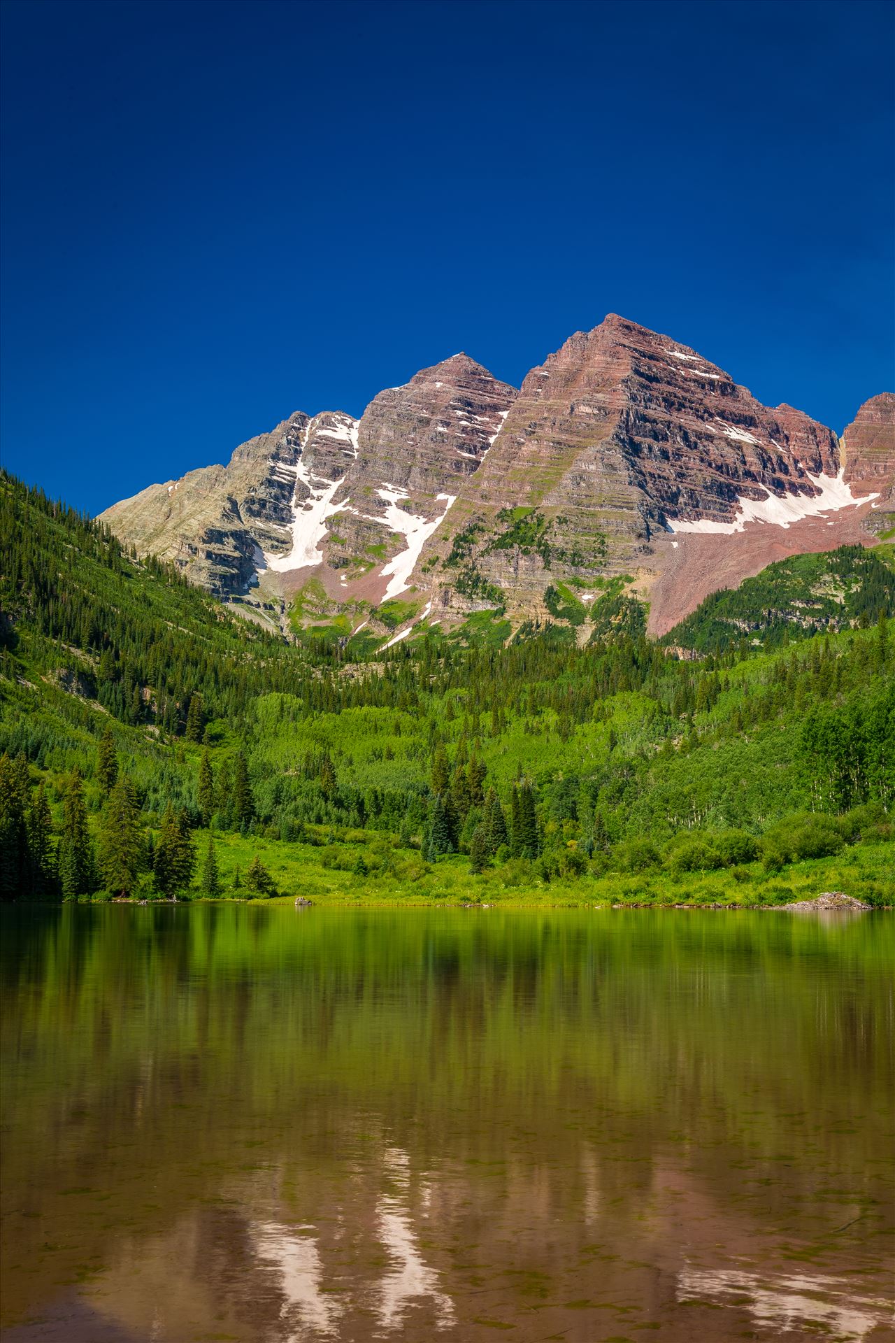 Maroon Bells in Summer No 07 The remaining snow reflected in the water, at the Maroon Bells near Aspen, Colorado. by Scott Smith Photos