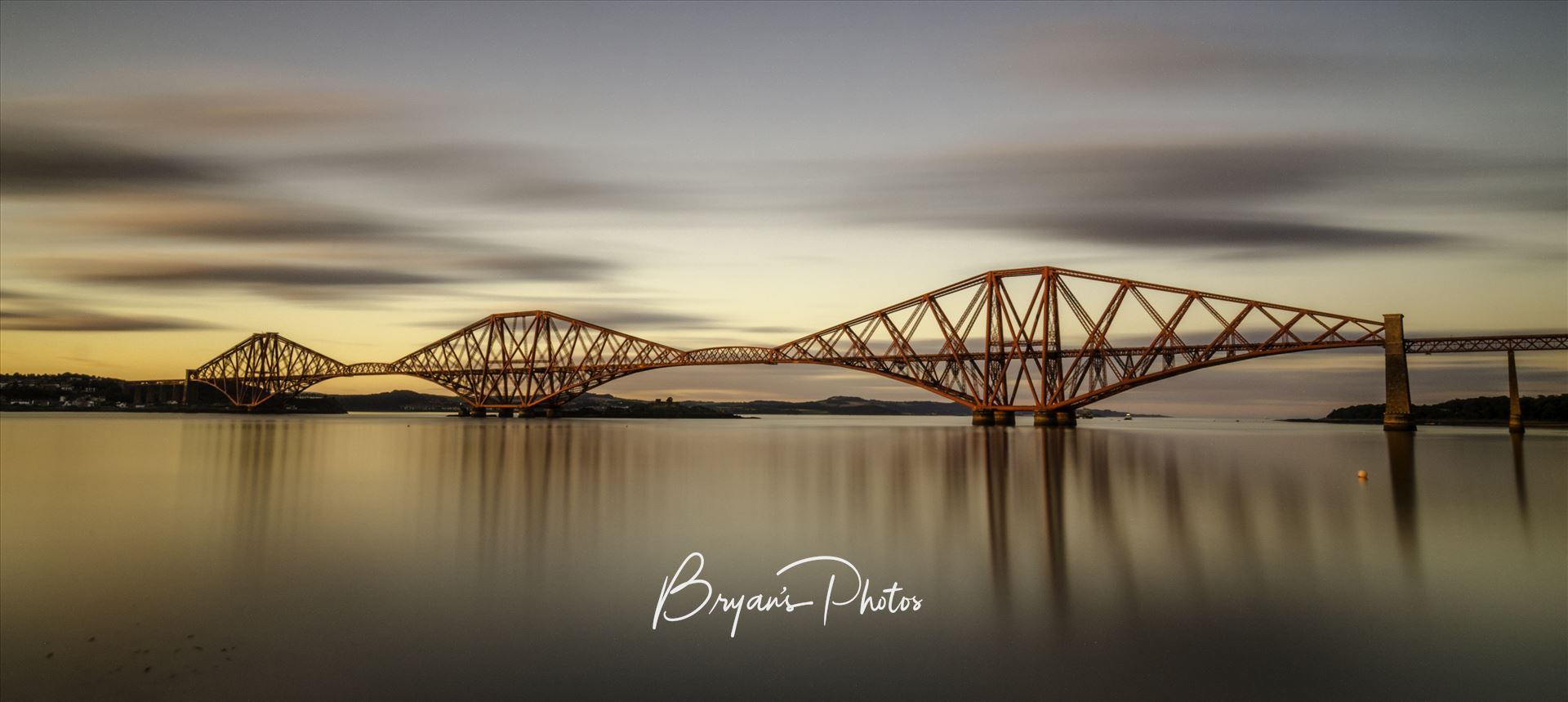 The Bridge at Sunset Panorama A panoramic long exposure photograph of the Forth Rail Bridge taken at sunset from South Queensferry. by Bryans Photos