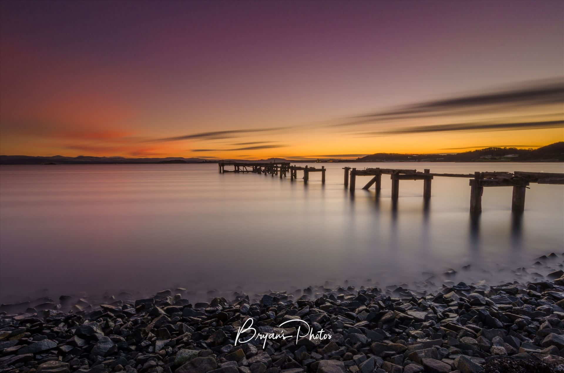 Sunset at Aberdour A photograph of the Abandoned pier at Aberdour on the Fife coast taken as the sun sets. by Bryans Photos
