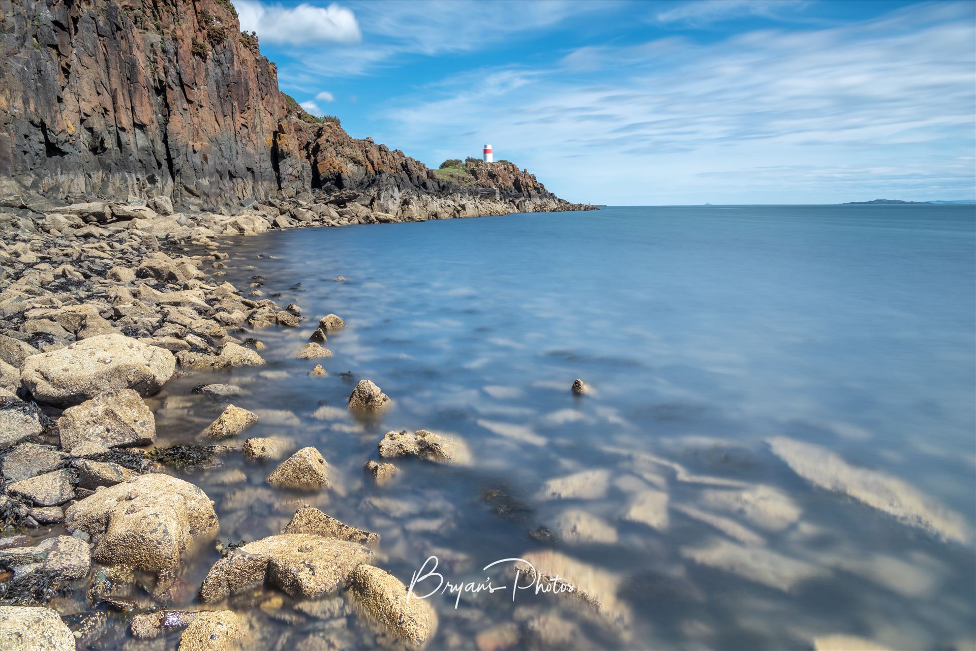 Blue Sky at Aberdour A photograph taken on a sunny summer afternoon at Hawkcraig point Aberdour on the Fife coast. by Bryans Photos