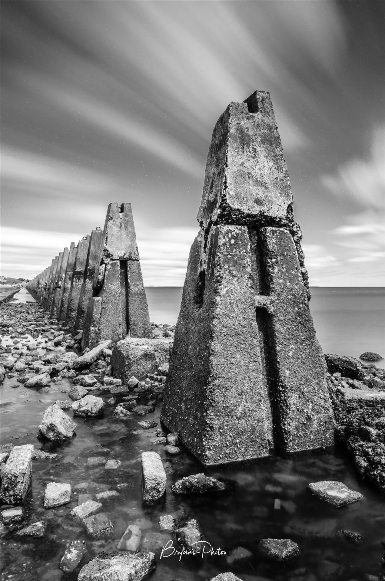 Cramond Portrait A black and white long exposure photograph of the causeway to Cramond Island. by Bryans Photos