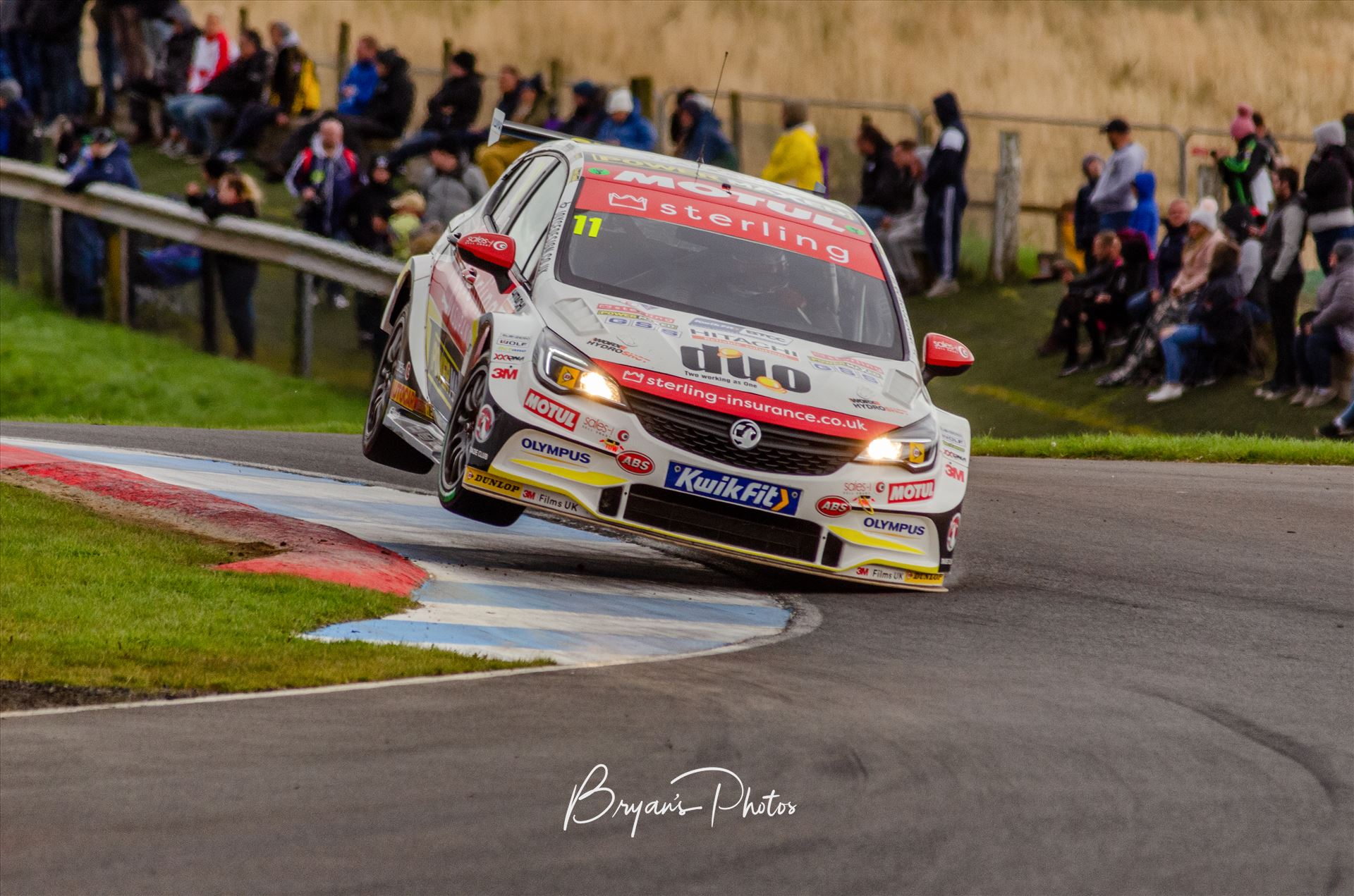 Jason Plato A photograph of Jason Plato getting his Astra on two wheels during qualifying for the 2019 touring cars race at Knockhill racing circuit. (photograph taken from public access area) by Bryans Photos