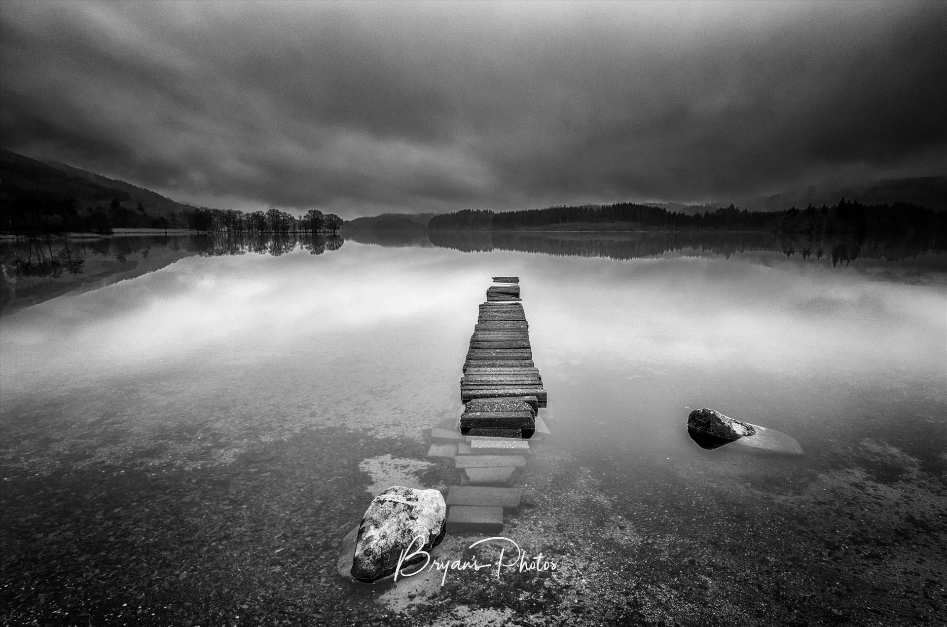 Loch Ard Landscape A black and white photograph of an old jetty at Loch Ard taken from Kinlochard. by Bryans Photos