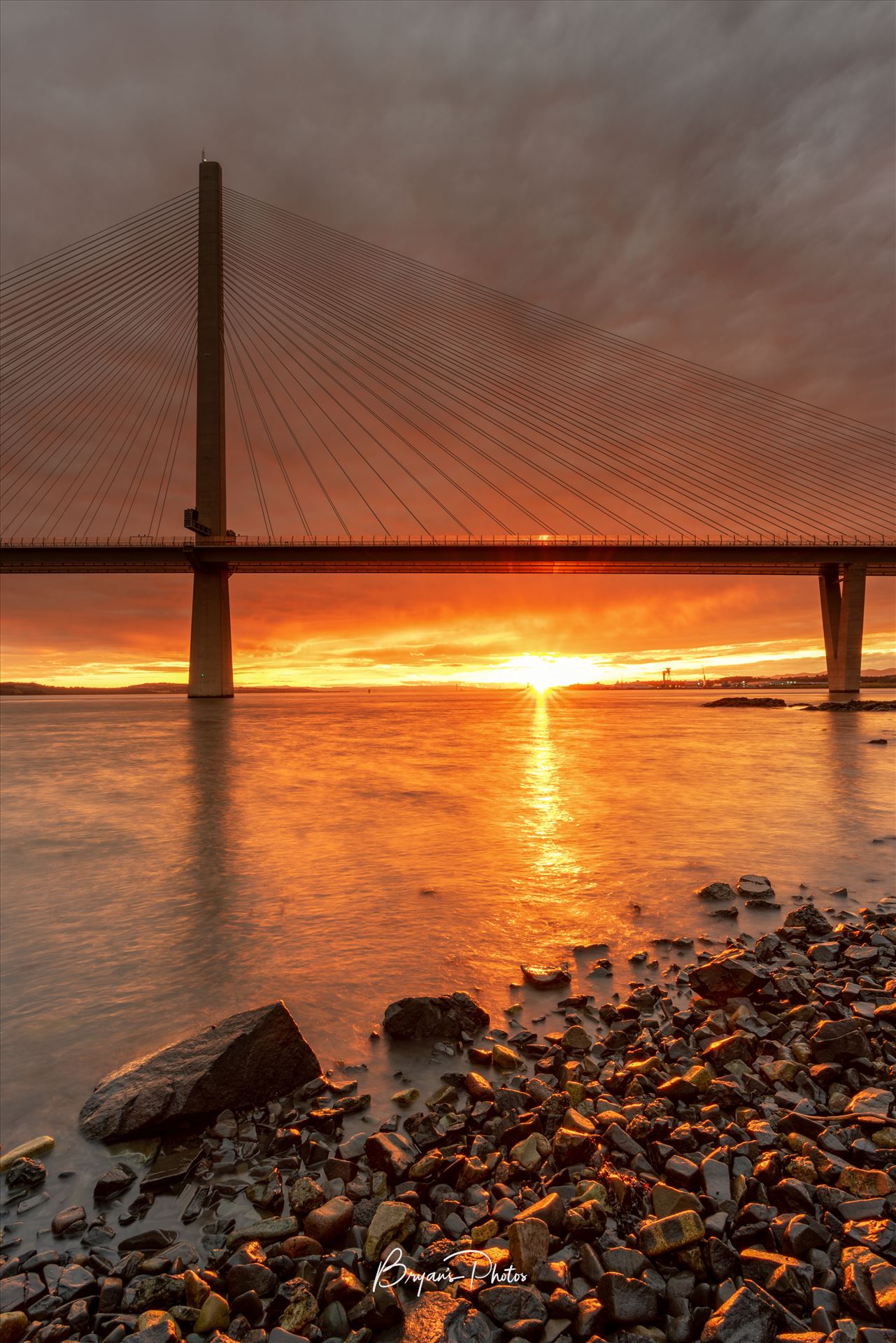 The Crossing at Sunset A photograph of the Queensferry crossing taken at sunset from North Queensferry. by Bryans Photos