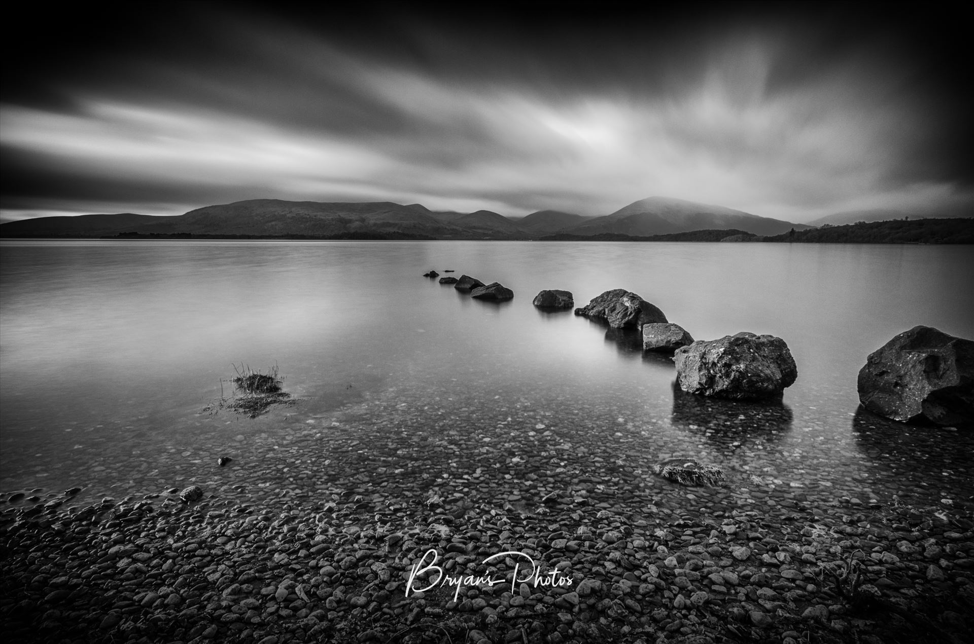 Moody Milarrochy A black & white photograph of Loch Lomond taken from Milarrochy Bay on the eastern shore of the loch near Balmaha. by Bryans Photos